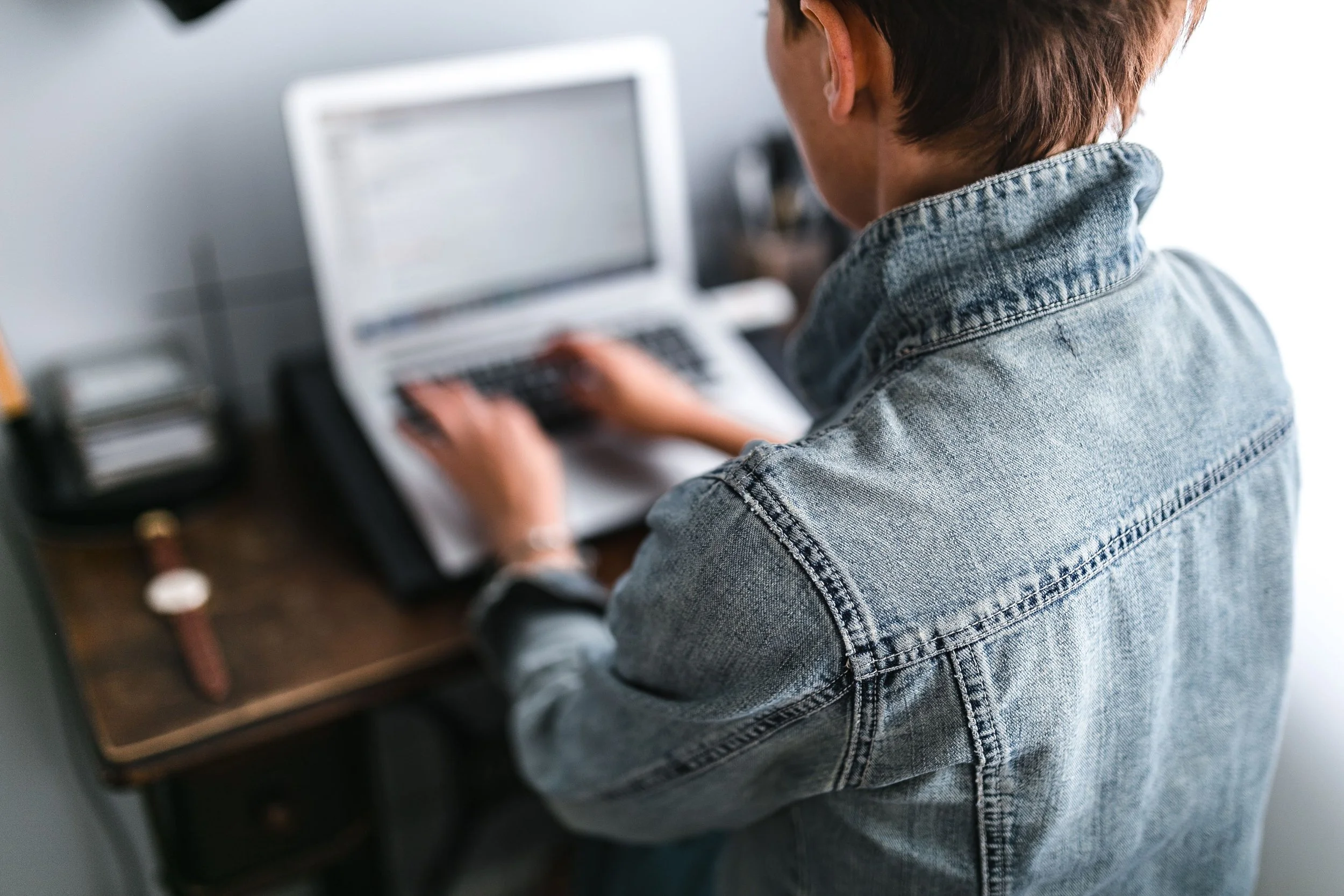 woman working on computer at a home office desk