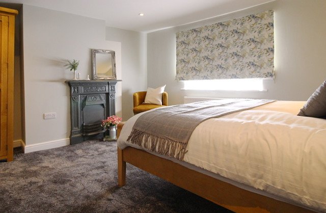 The first bedroom has feature fireplace(not in use) & a double bed. There is a wardrobe & chest of drawers which provide plenty of storage no matter how long your stay.