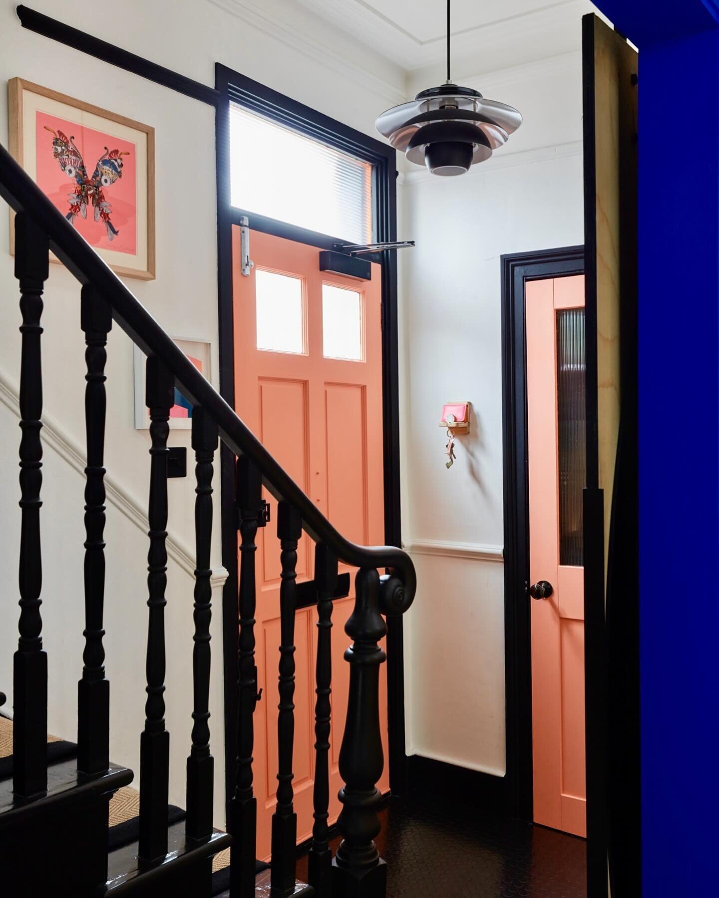 Visitors stepping inside this traditional looking Victorian end of terrace, are greeted with a wow of flamingo-like coral and electric blue. 

Original features sit alongside industrial new additions like the sliding barn door into the reception room