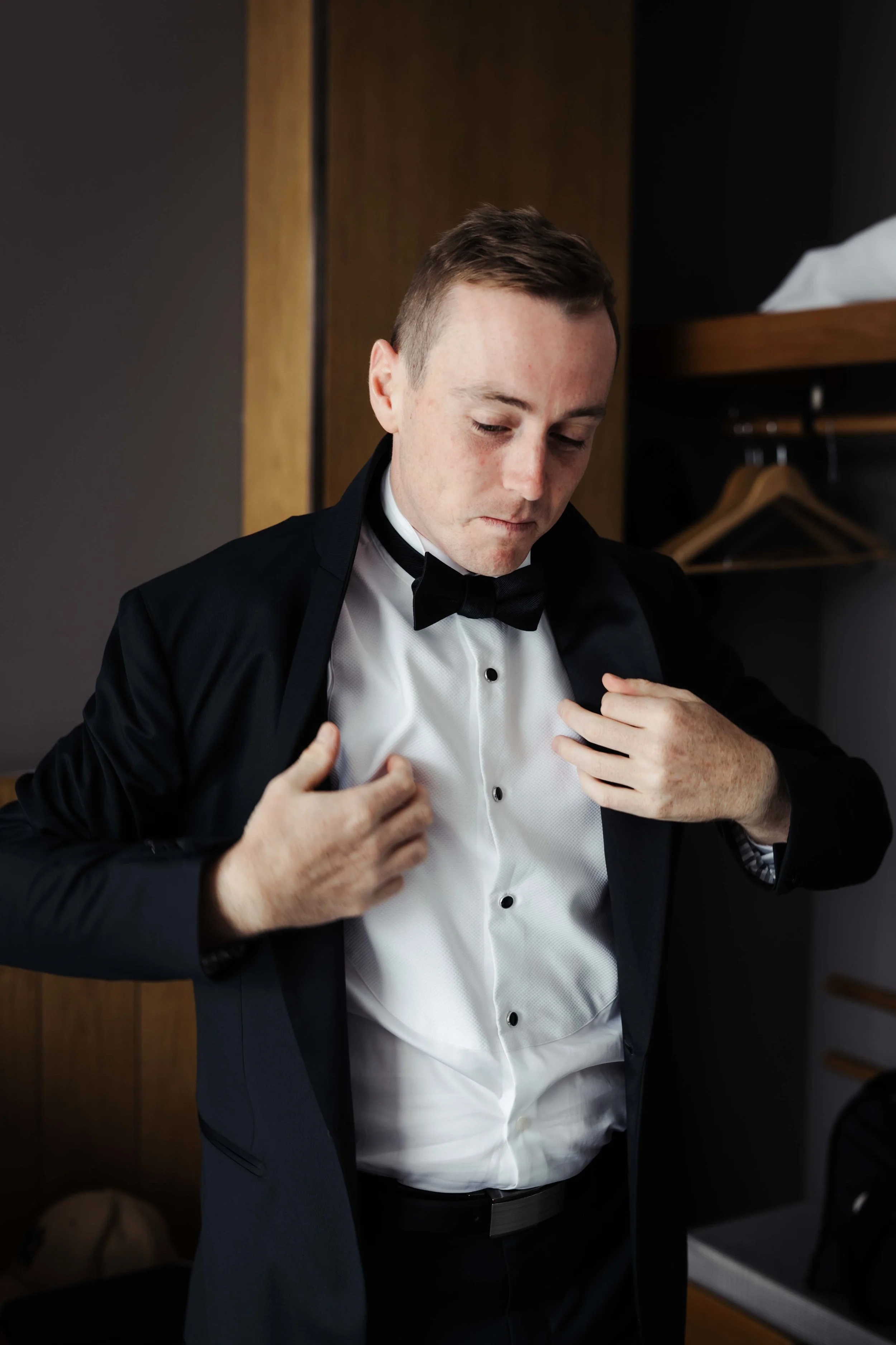 Wedding photography of a wedding in Hobart, Tasmania. Happy Groom getting ready with groomsman.