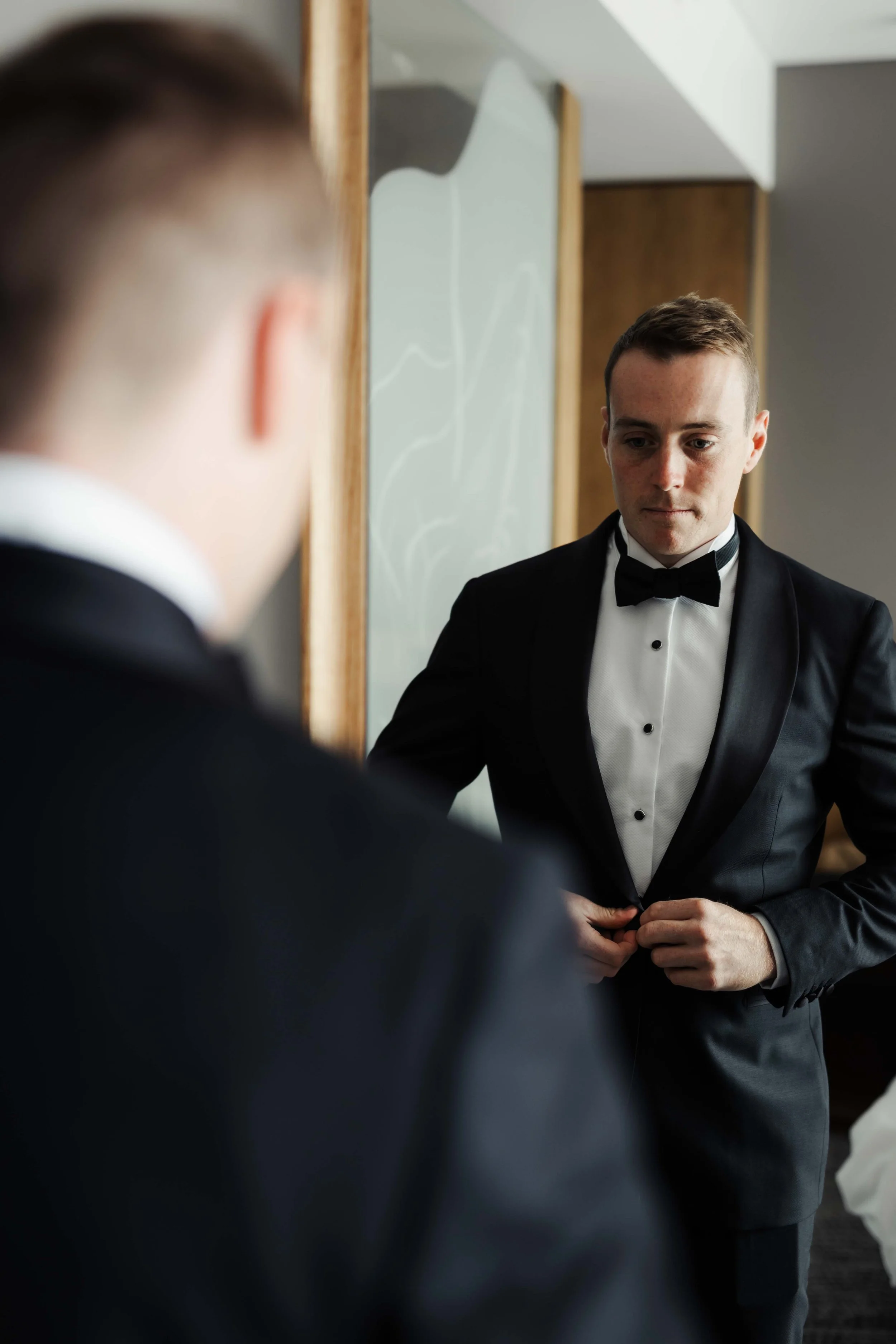 Wedding photography of a wedding in Hobart, Tasmania. Happy Groom getting ready with groomsman.