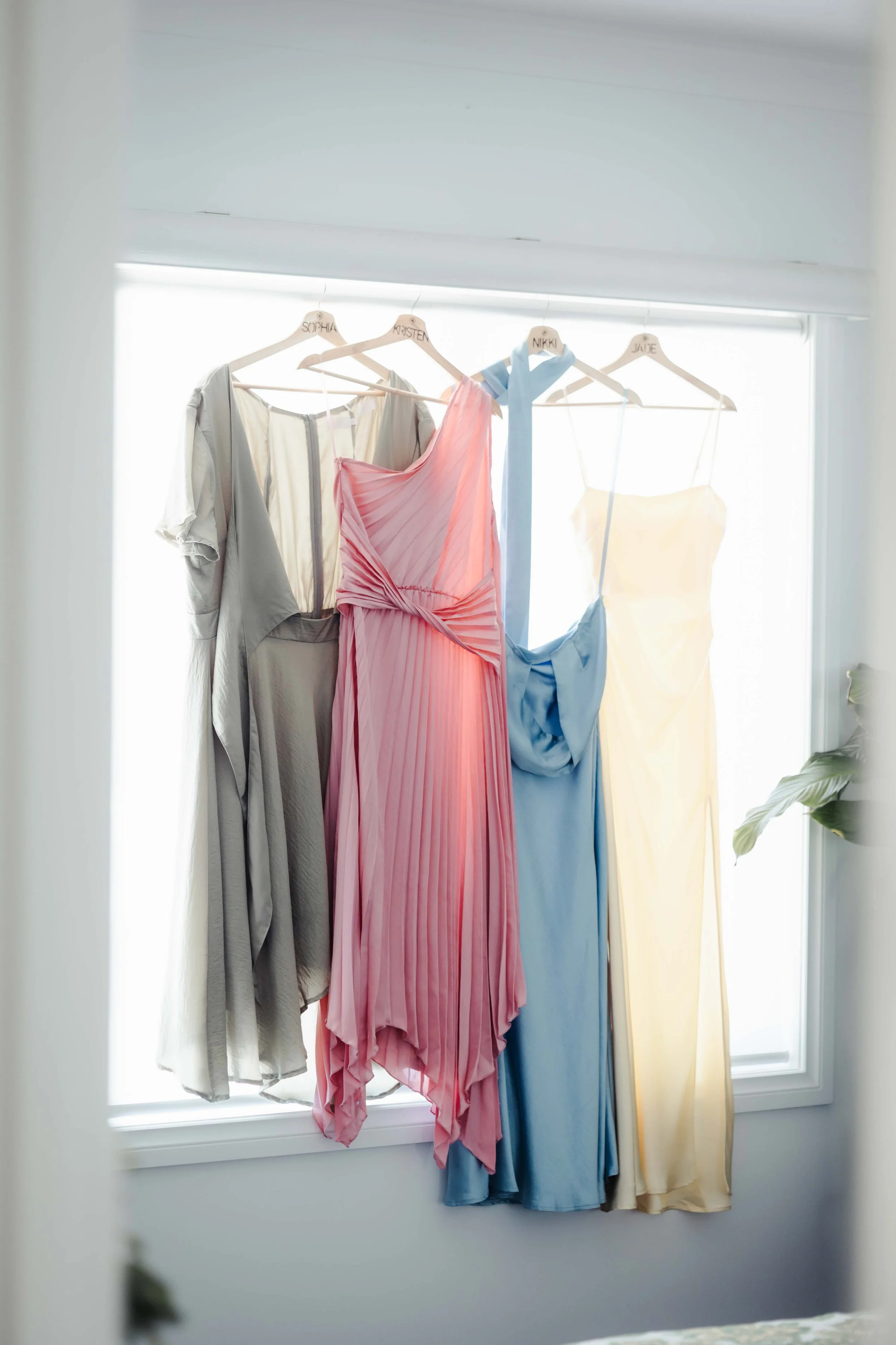 Dresses hanging up in Victoria wedding photos captured by Finding Happy Photography.