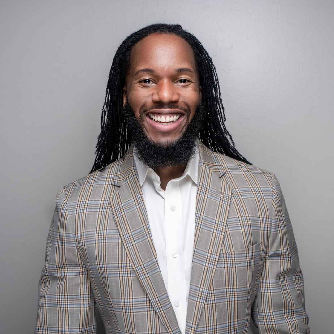 Dr. Vince in grey sports coat and white shirt with smile