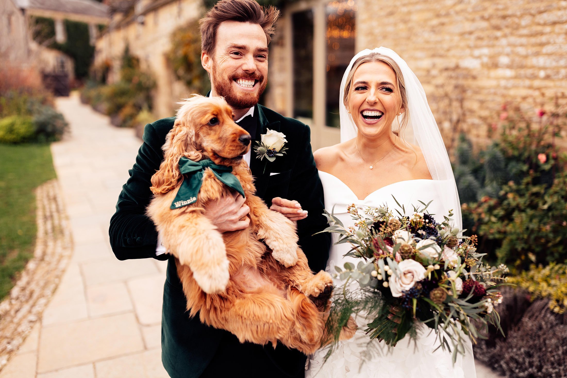 couple with dog at winter wedding Caswell house Oxfordshire