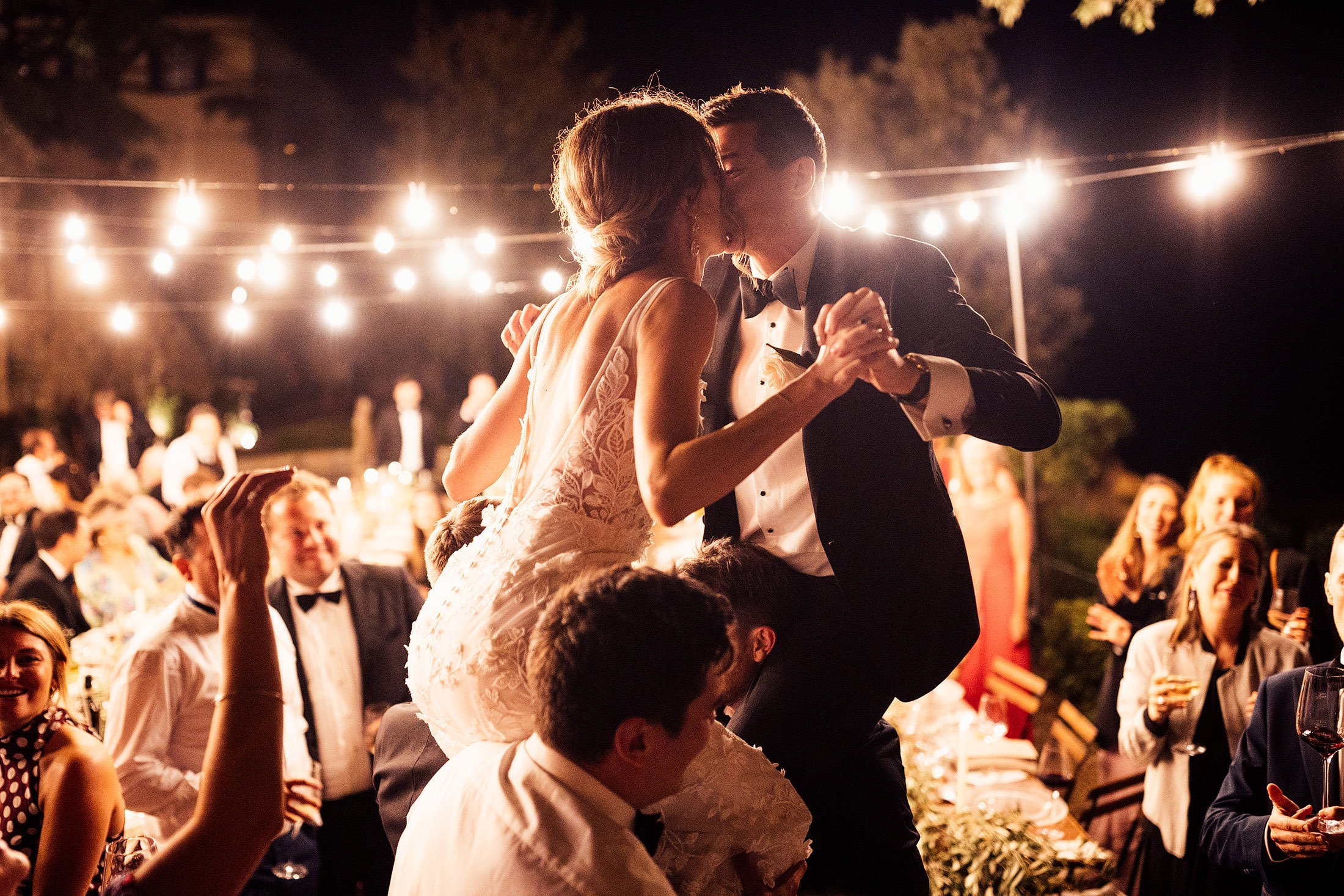 couple on shoulders in outdoor Tuscany dance floor 