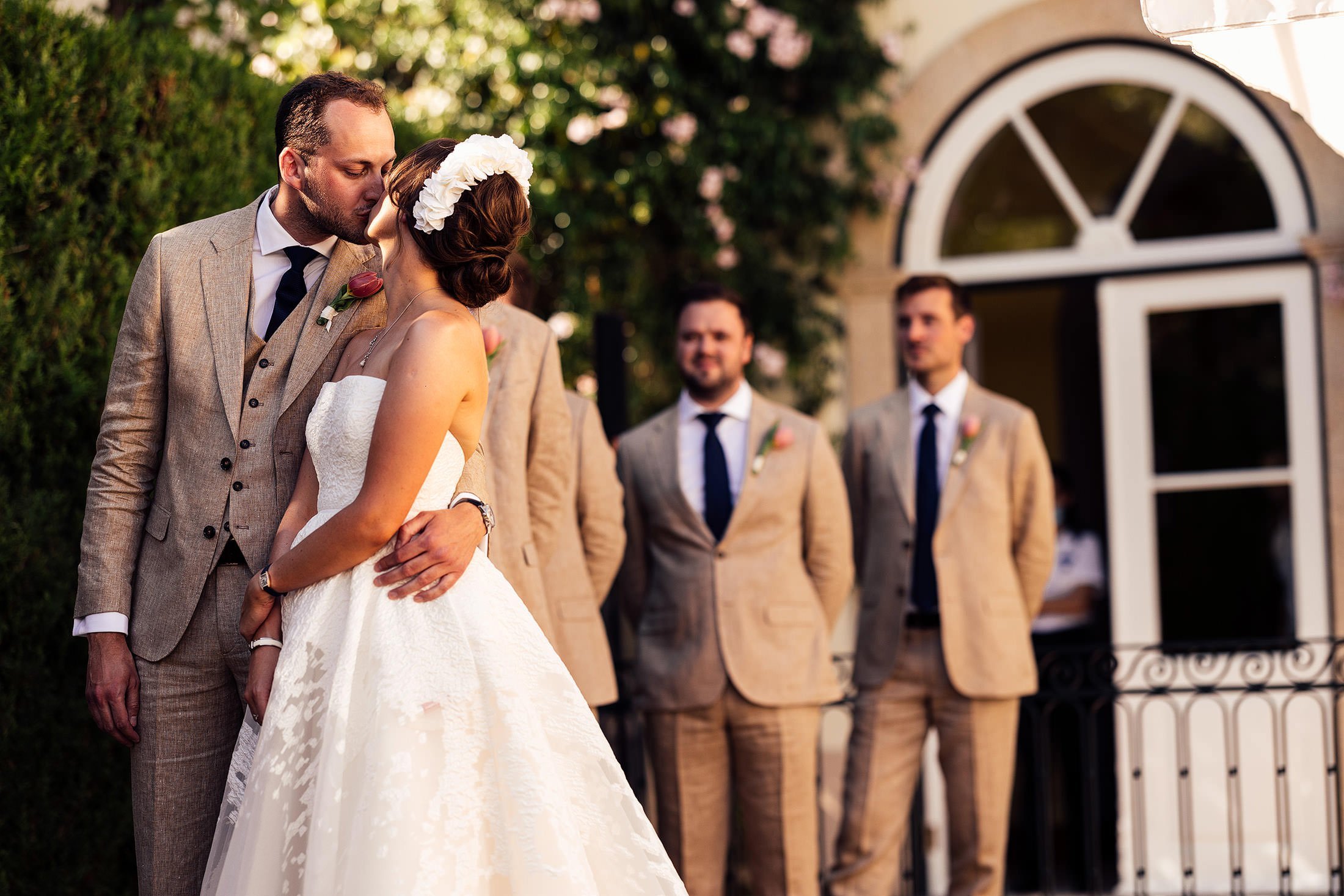 couple kiss at outdoor wedding ceremony in Portugal
