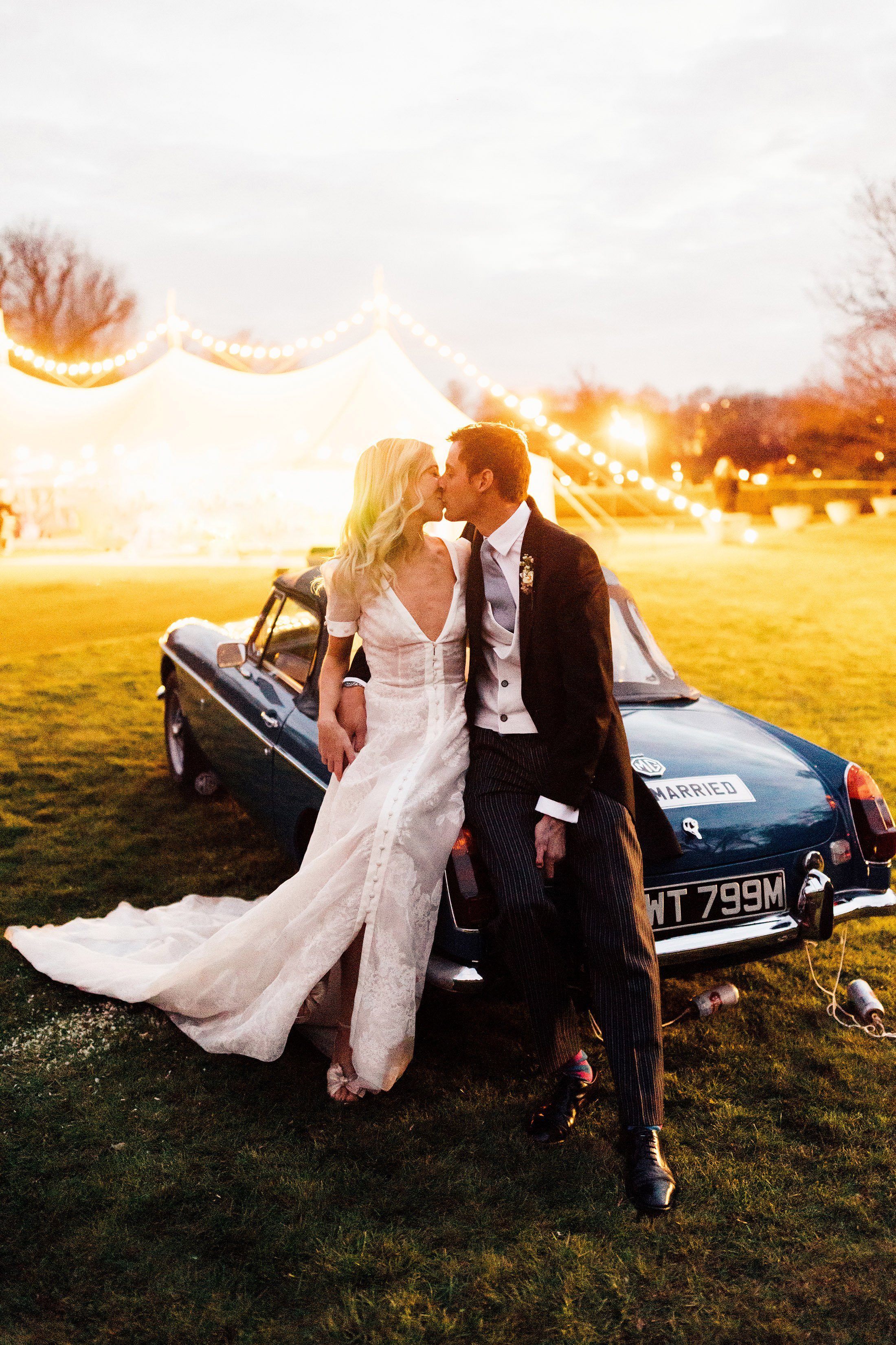 couple kiss on vintage mg with marquee in background