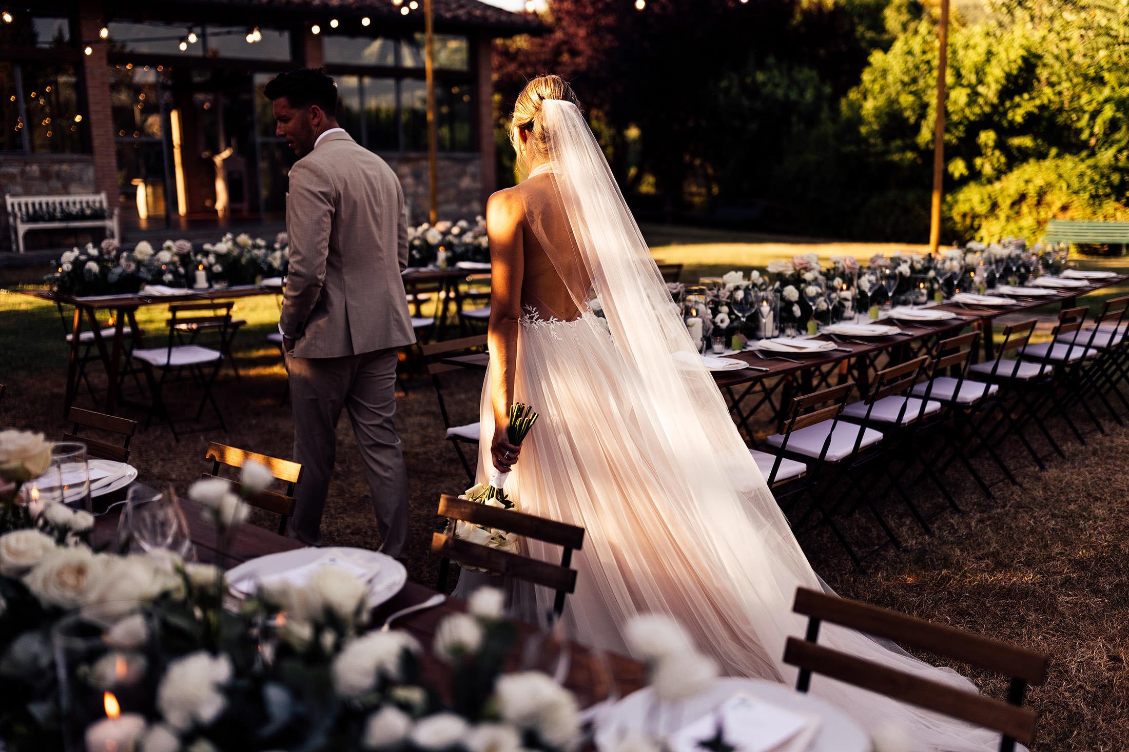 couple look at table scape at tuscan wedding in Borgo corsginano