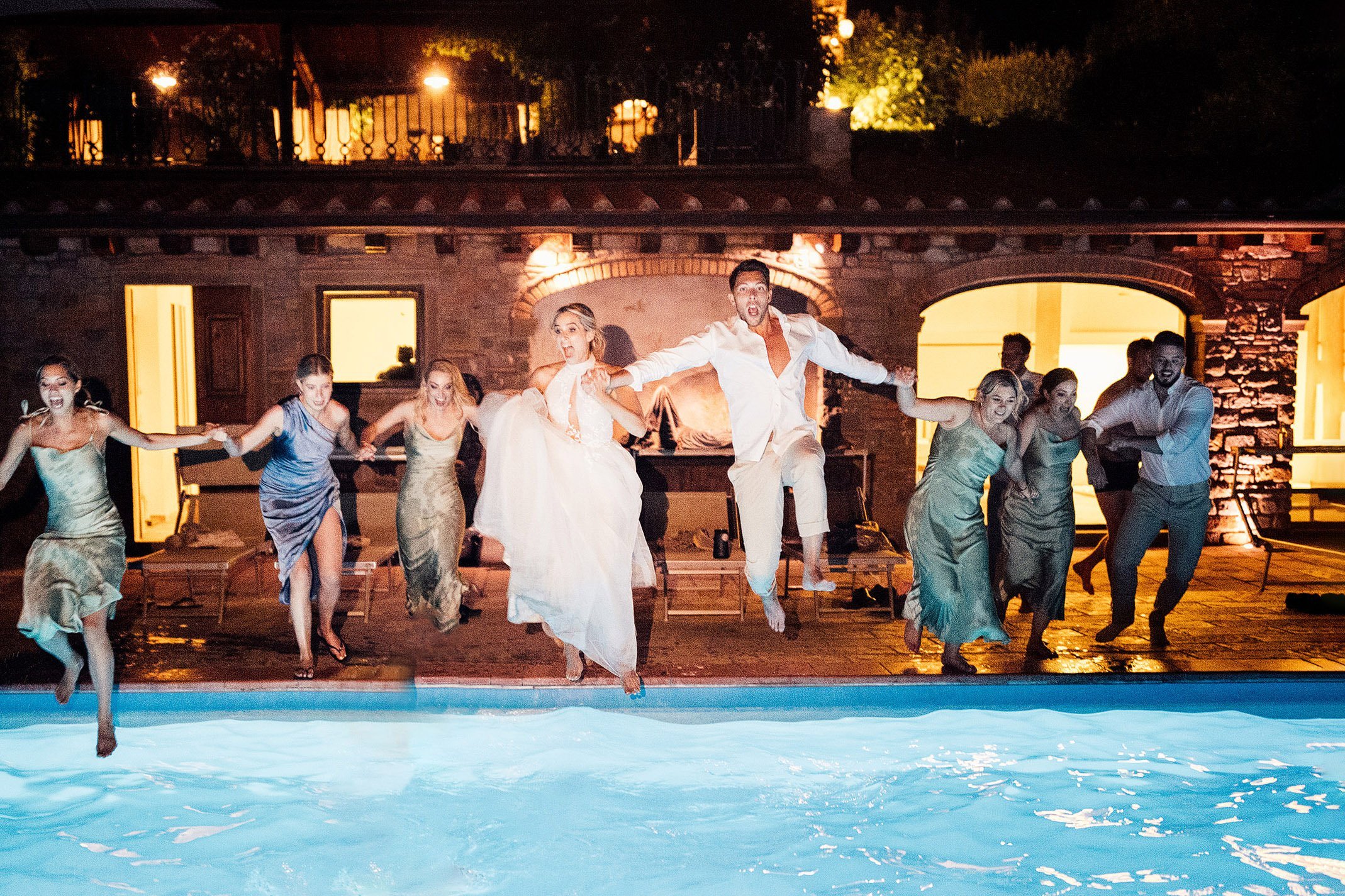 bridal party jump in pool at Tuscany wedding 