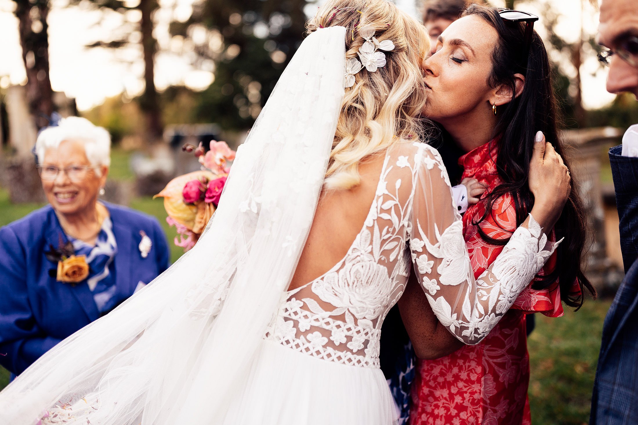 guest kisses bride after confetti