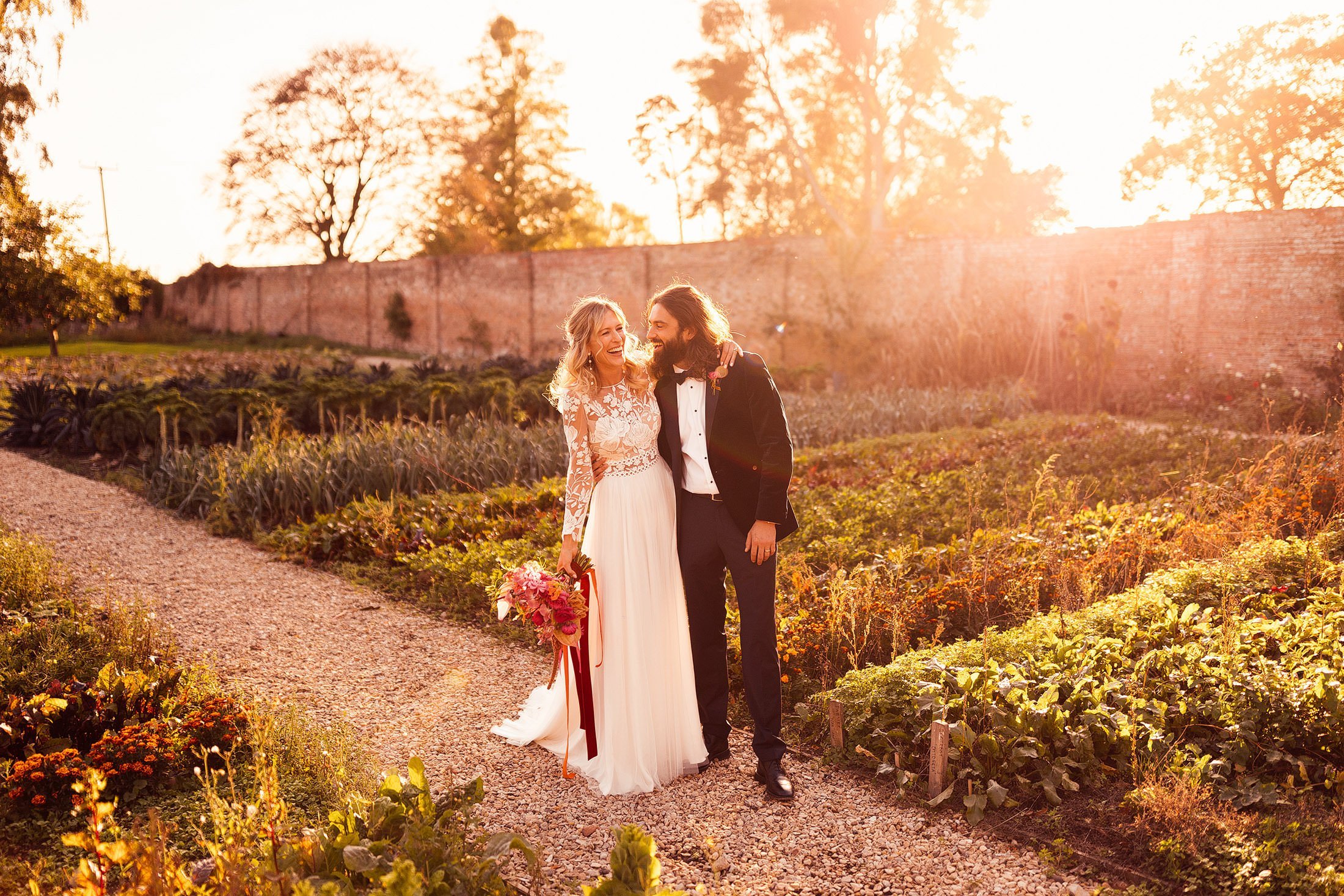 couple portrait in cotswold field during sunset with bride in margaux tardits dress