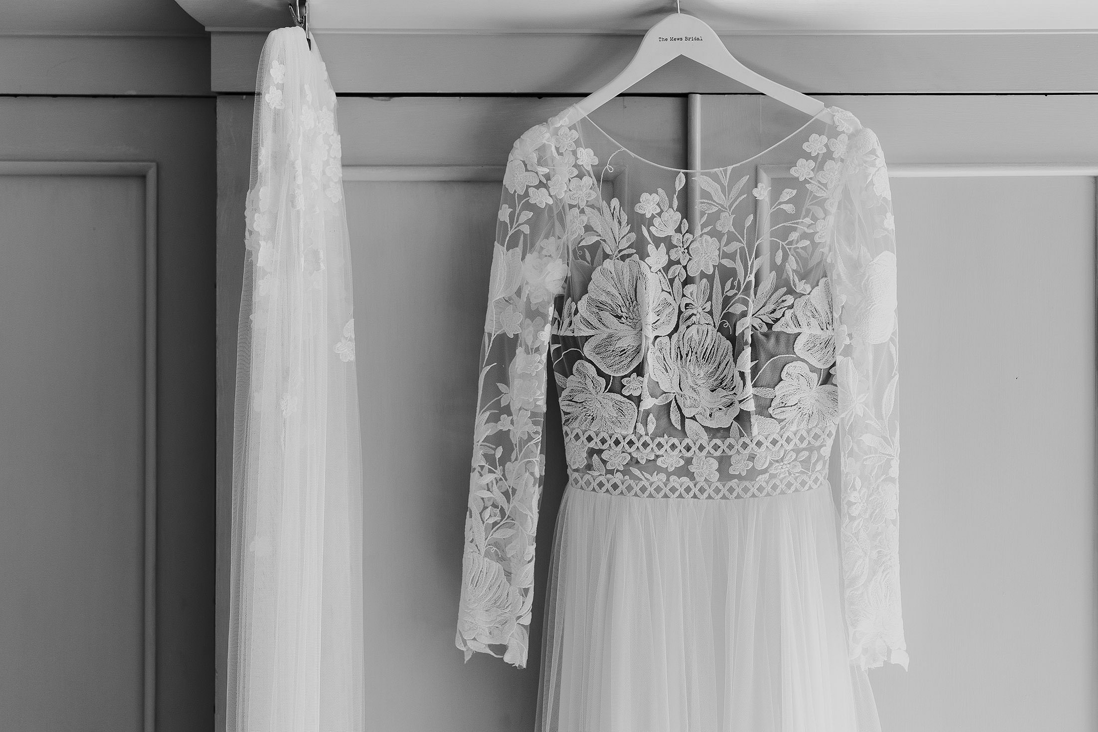 margaux tardits dress hanging on door from the mews bridal