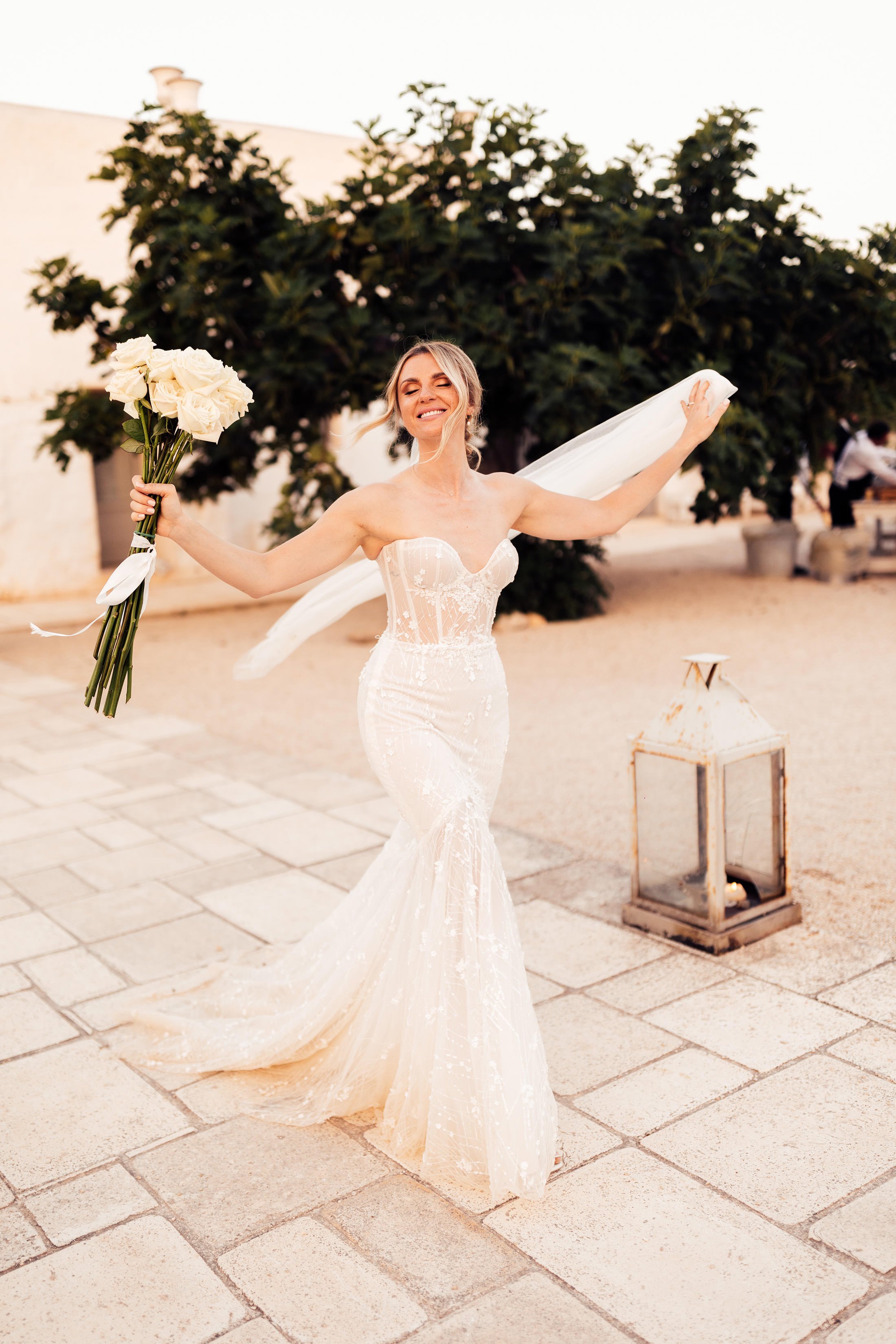 bride smiles and holds bouquet in masseria potenti 