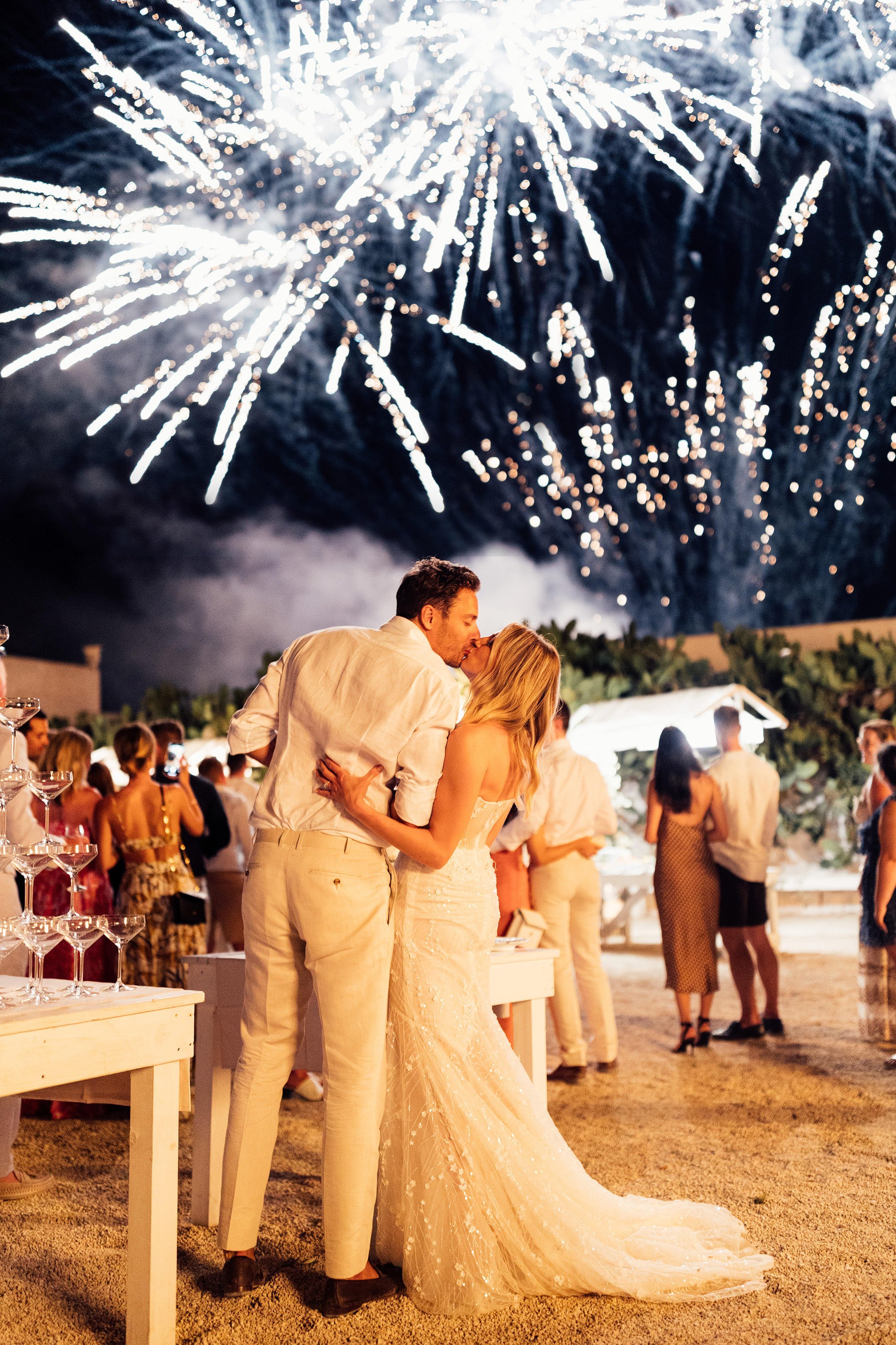 couple kiss whilst watching fireworks over masseria potenti Puglia 