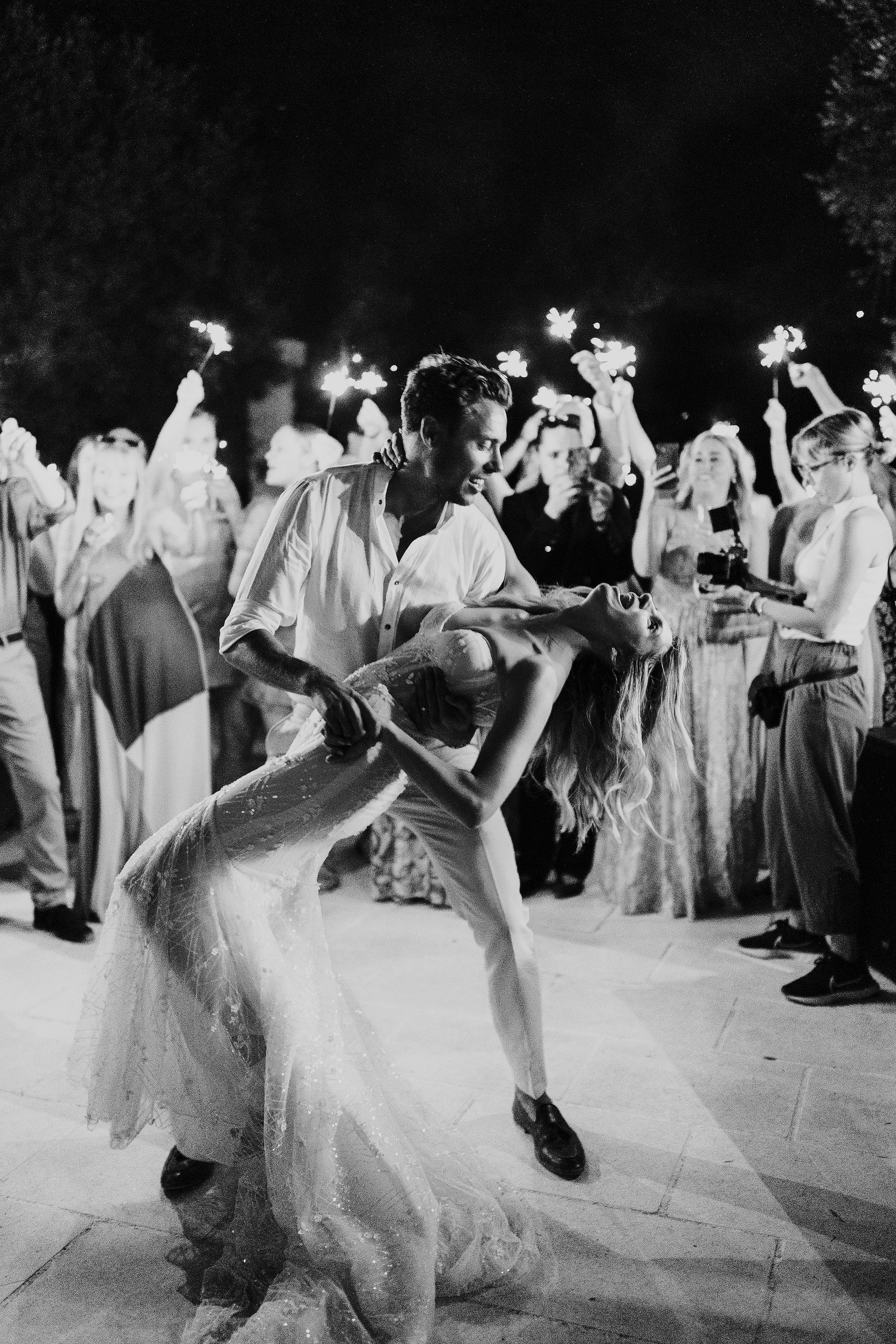 couples first dance with guests holding sparklers