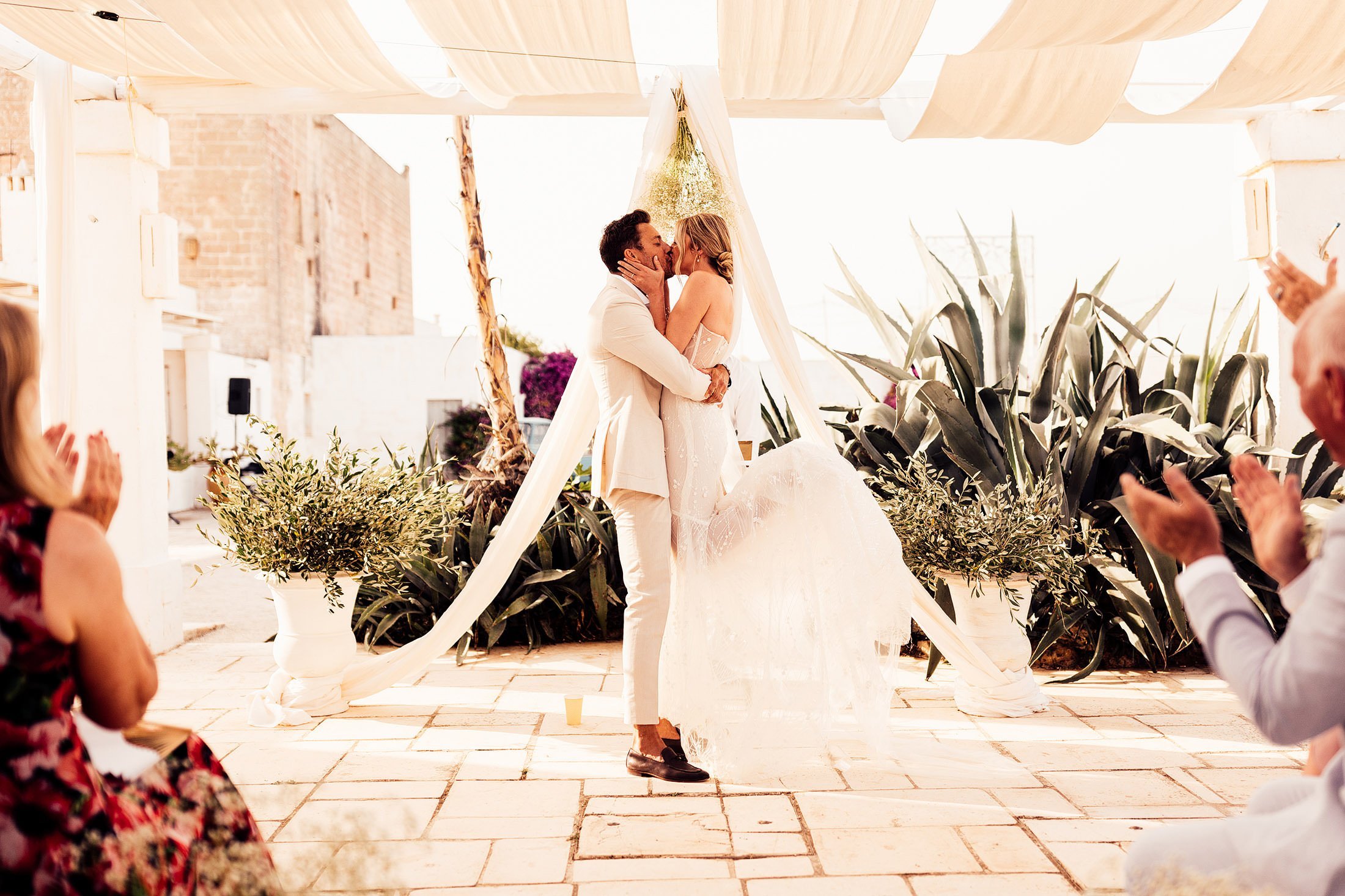 couples first kiss in masseria potenti wedding venue