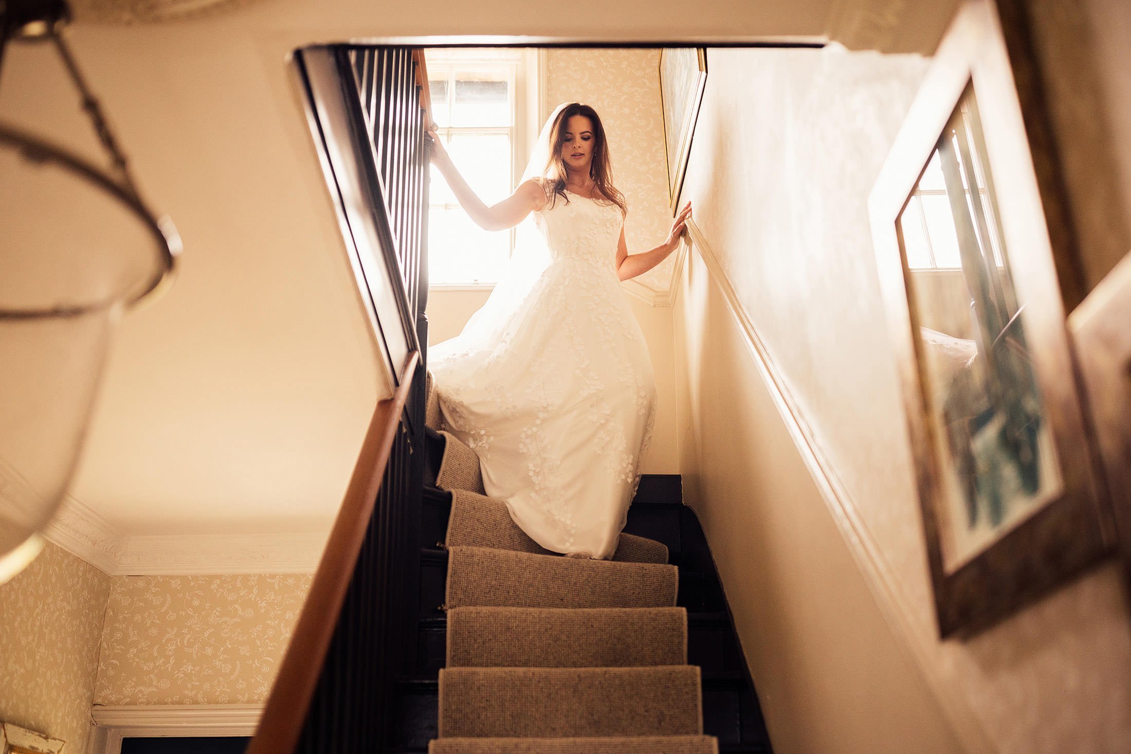 bride in Phillipa Lepley dress walks down stairs at family home wedding