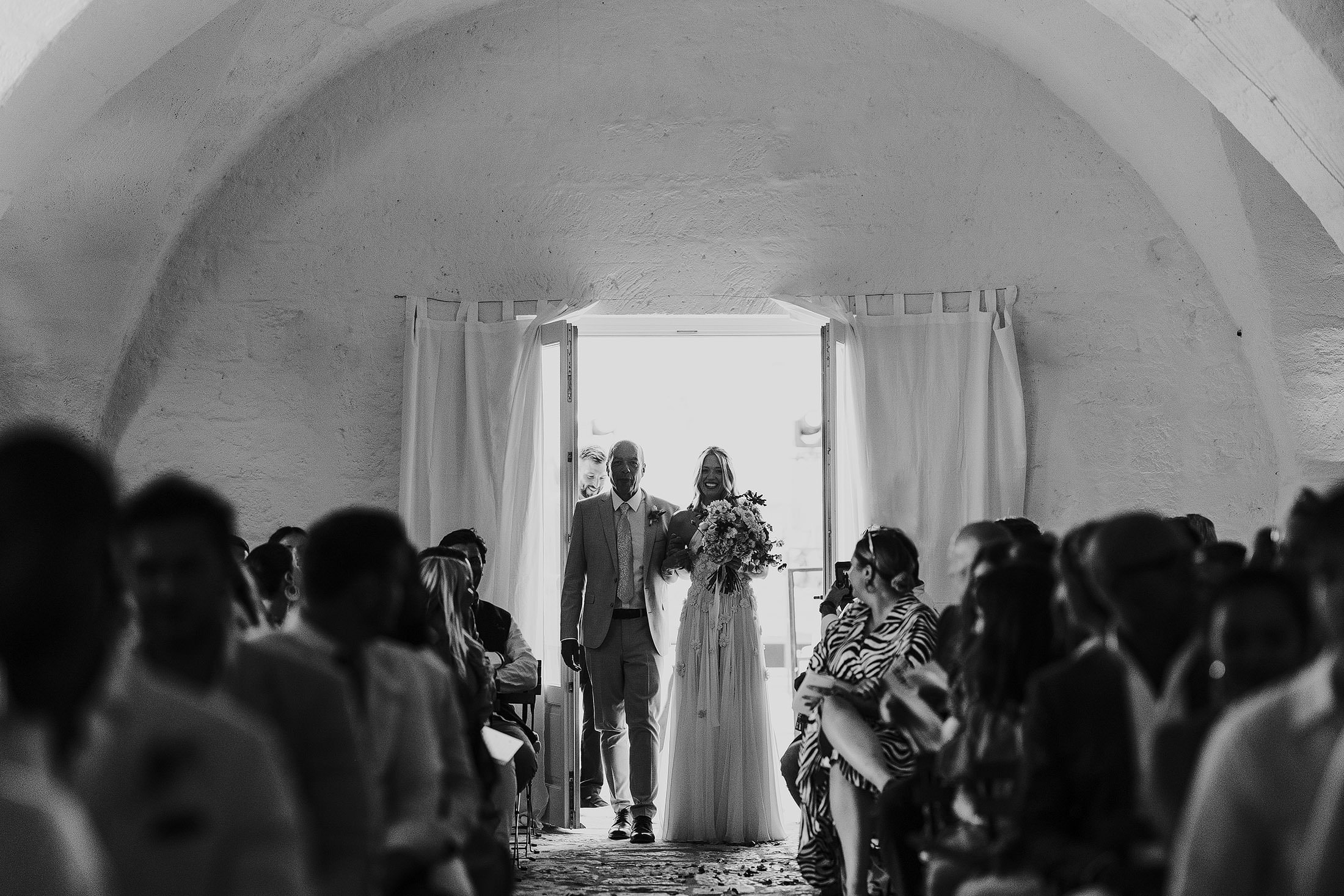 bride enters ceremony with dad at masseria mangiamuso