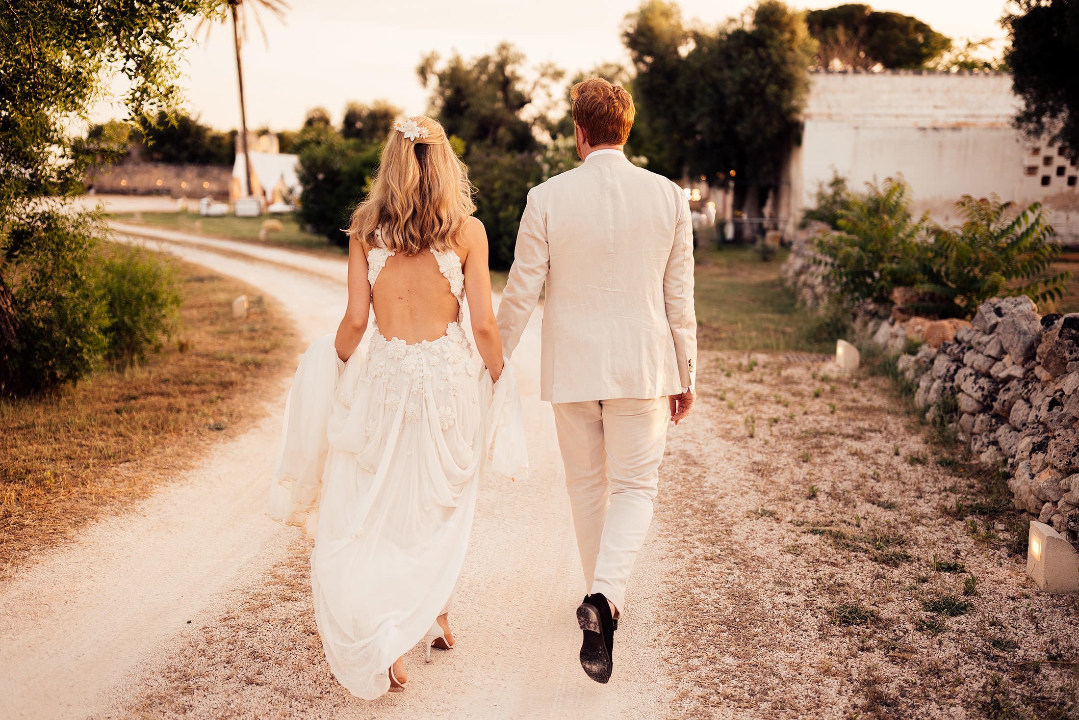 couple walk in sunset in Puglia wedding venue masseria mangiamuso