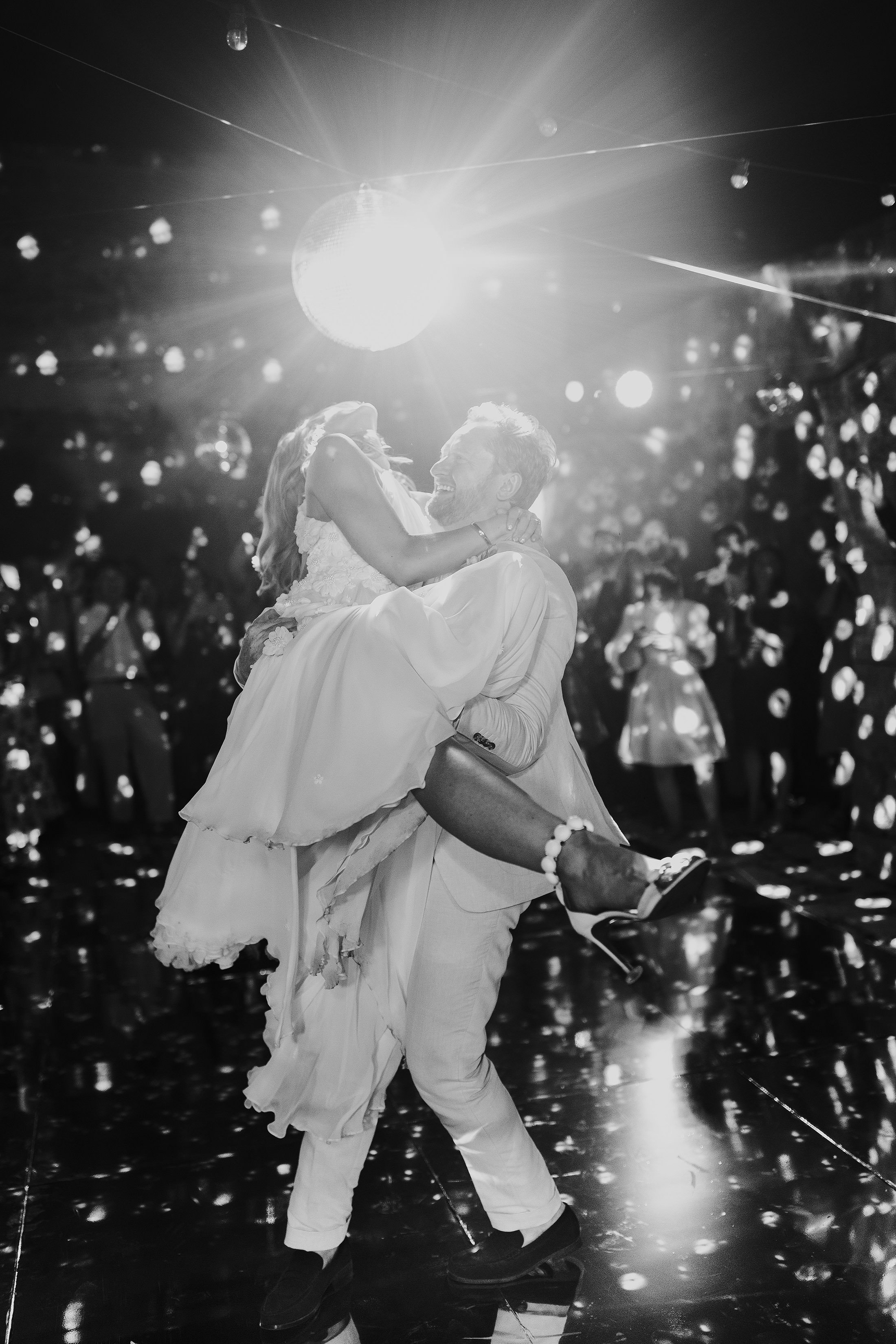 bride and groom first dance under disco ball at masseria mangimuso