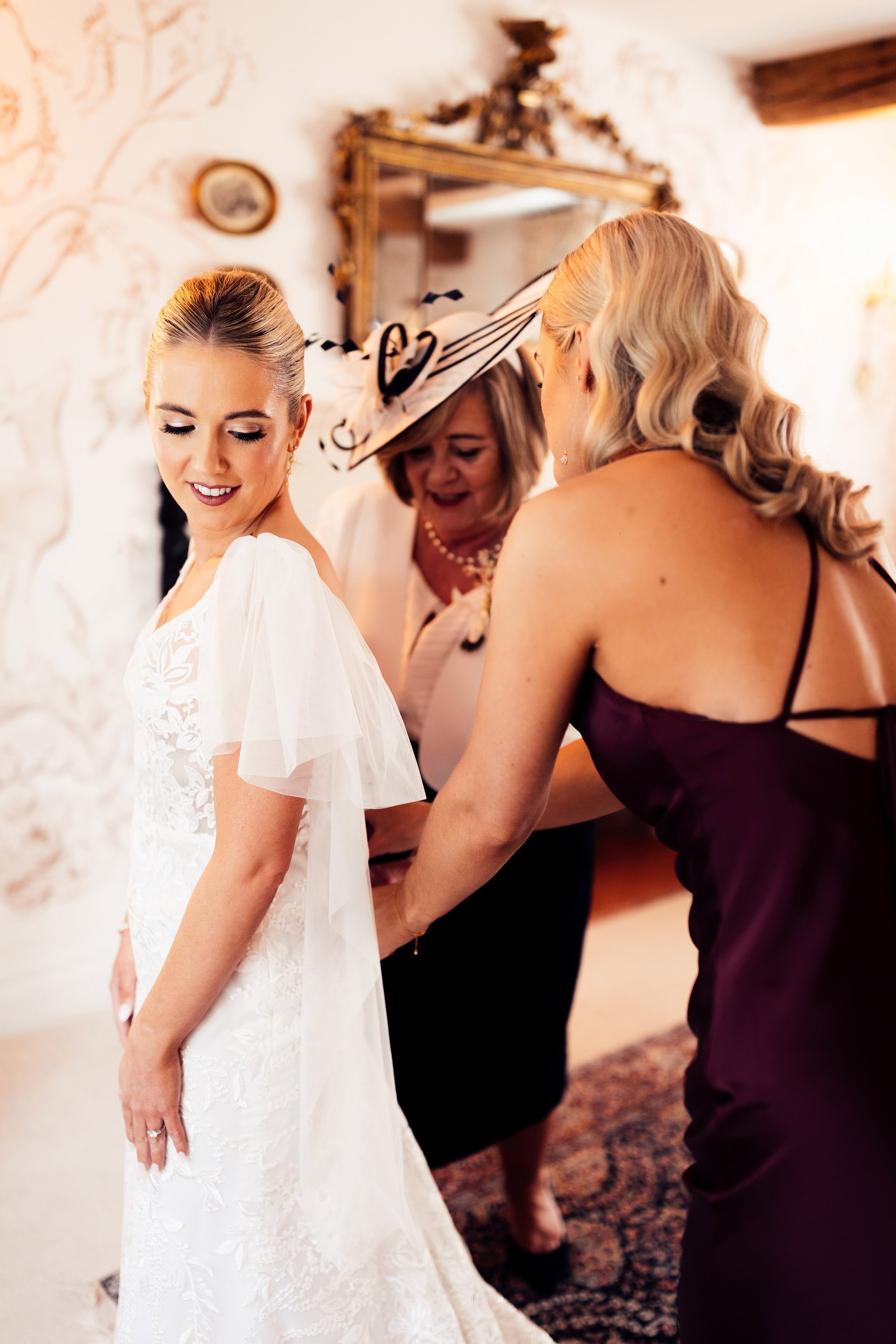 bride getting into made with love bridal dress 