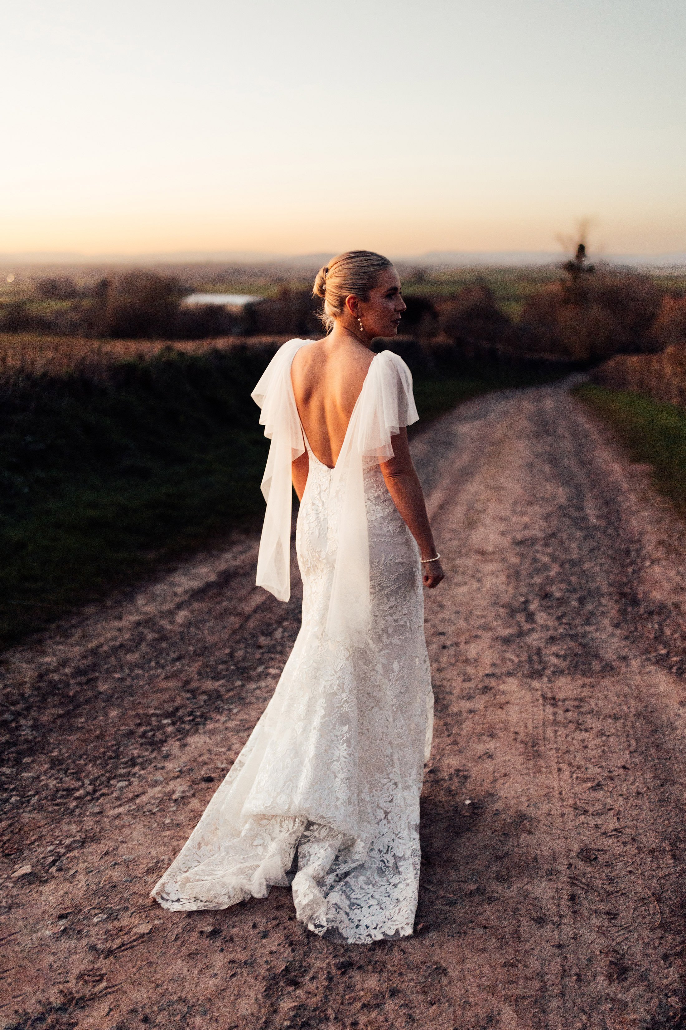 bride in made with love bridal dress with detachable wings