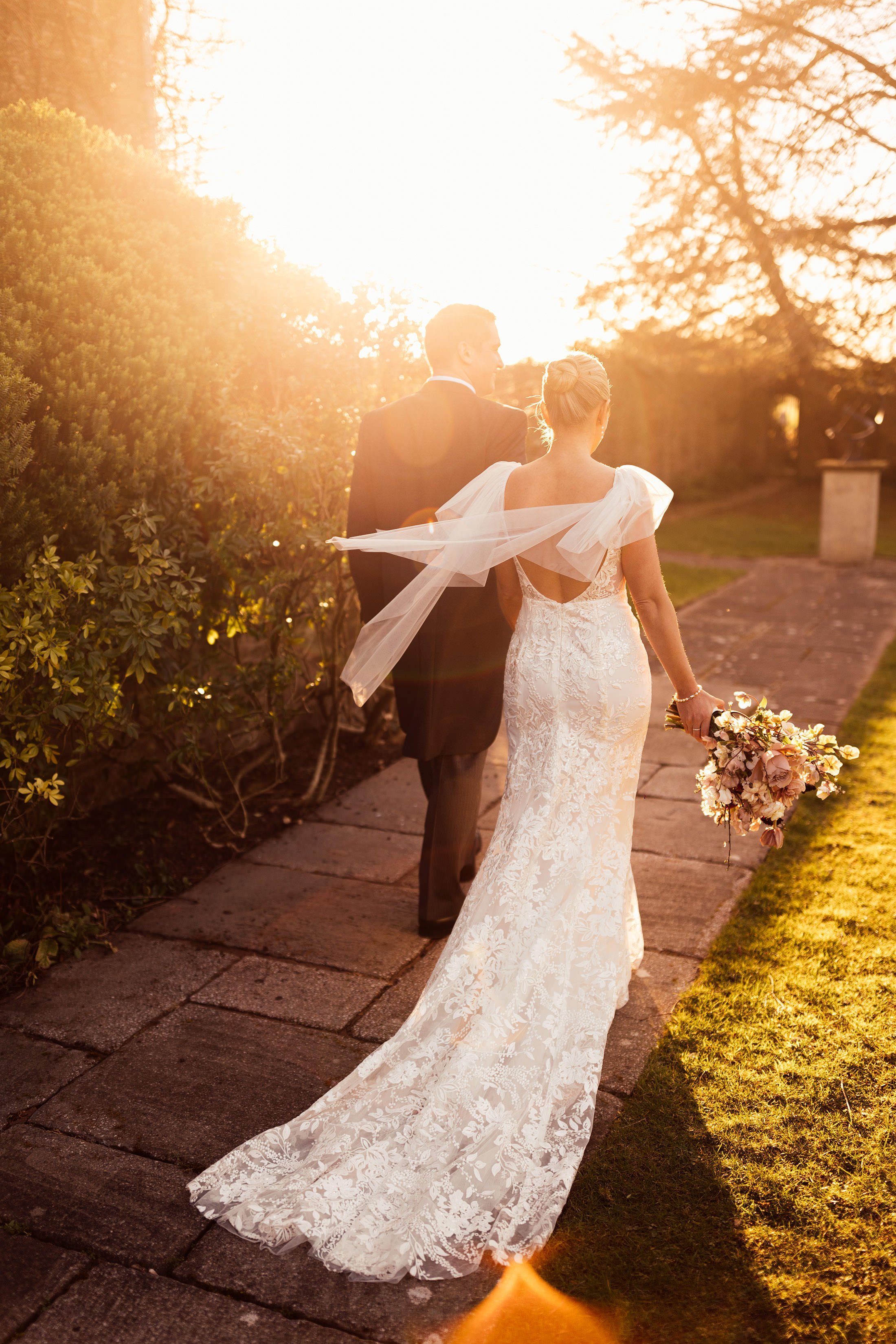 couple walk in sunset at dewsall court Hereford
