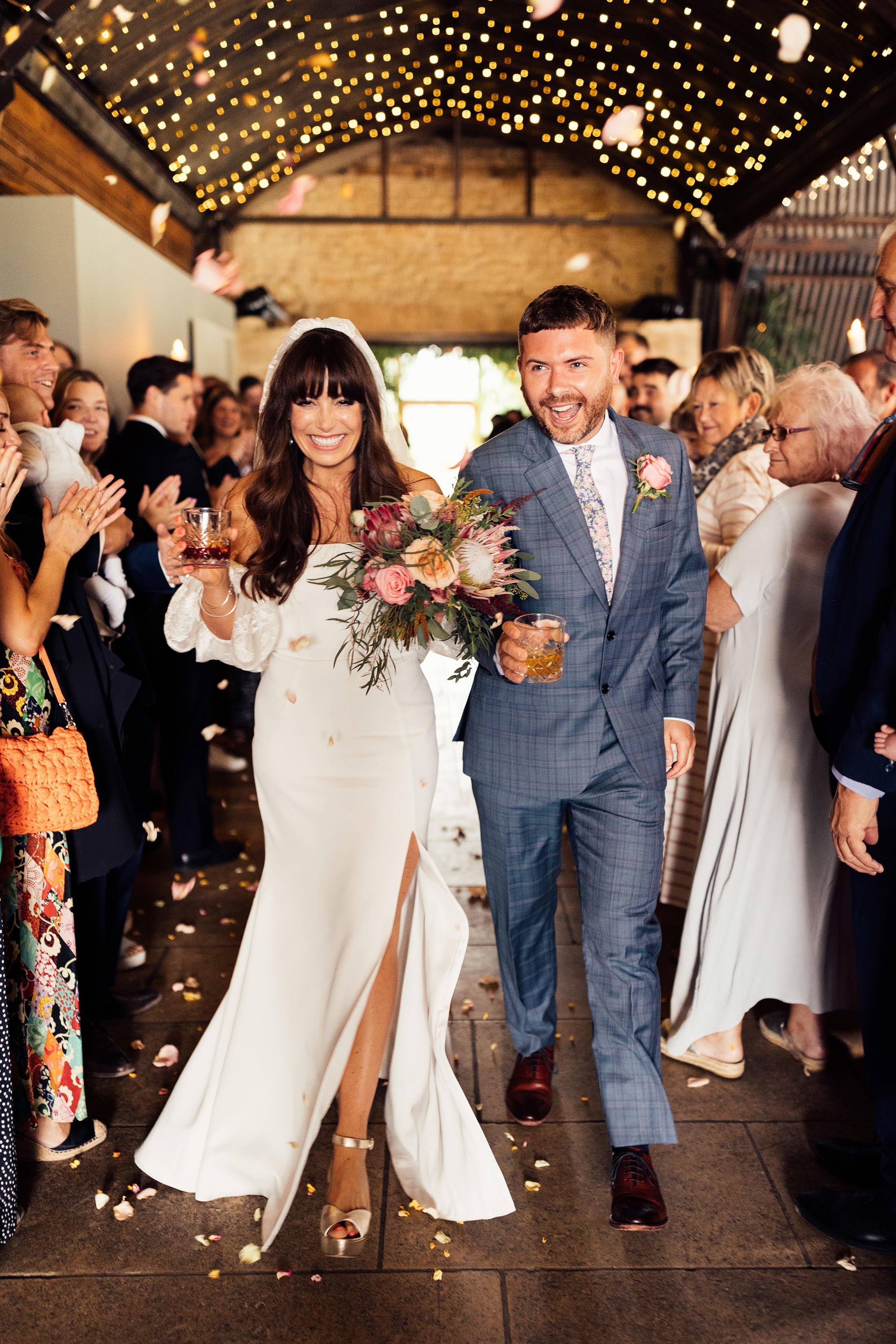 confetti moment at stone barn cotswolds with bride in rime arodaky dress