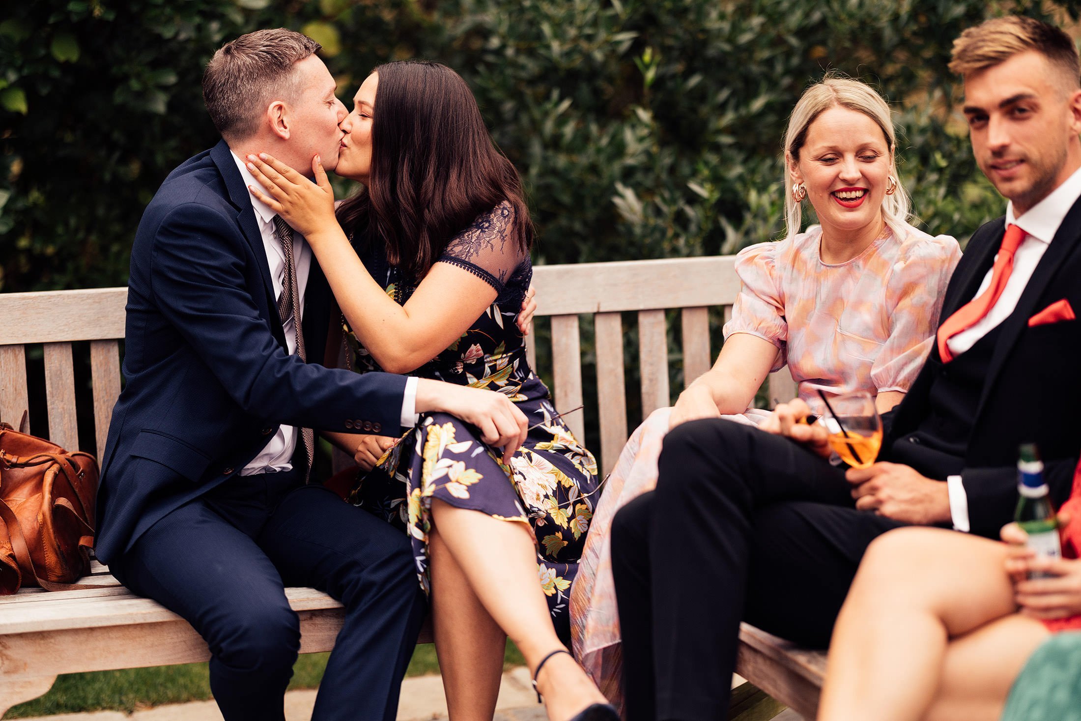 guests kiss outside rustic cotswold wedding venue