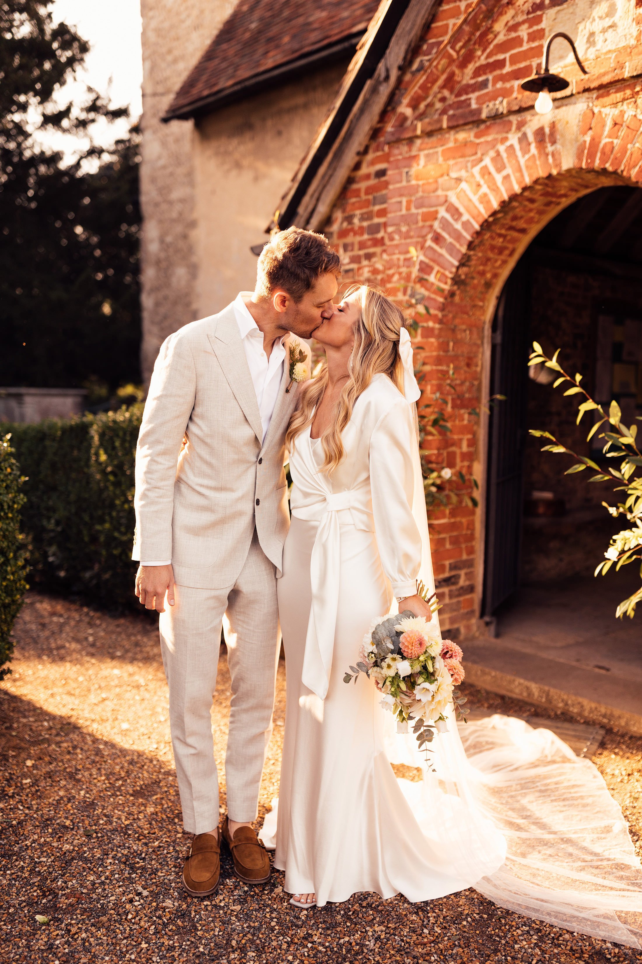 couple kiss outside church in Hampshire