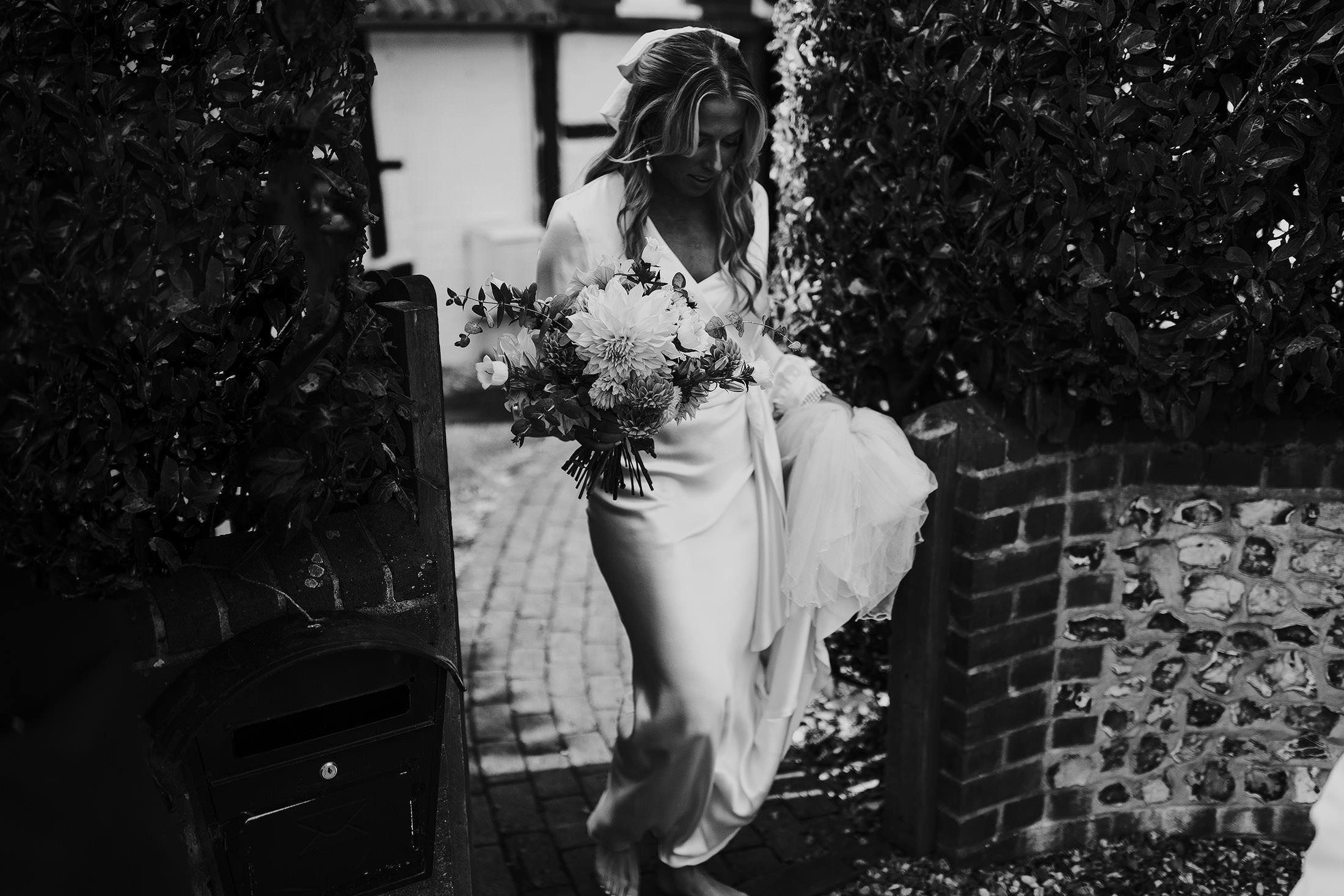 bride walks in own studio dress with long sleeves