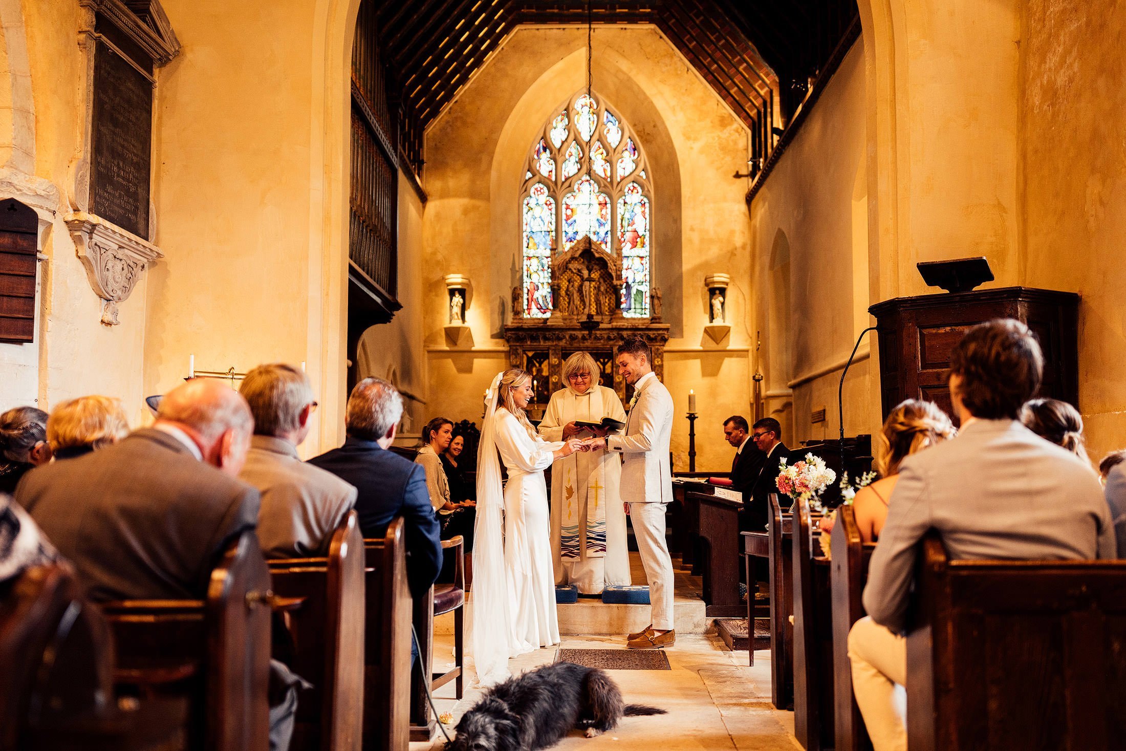 couple exchange rings at church in upper farringdon