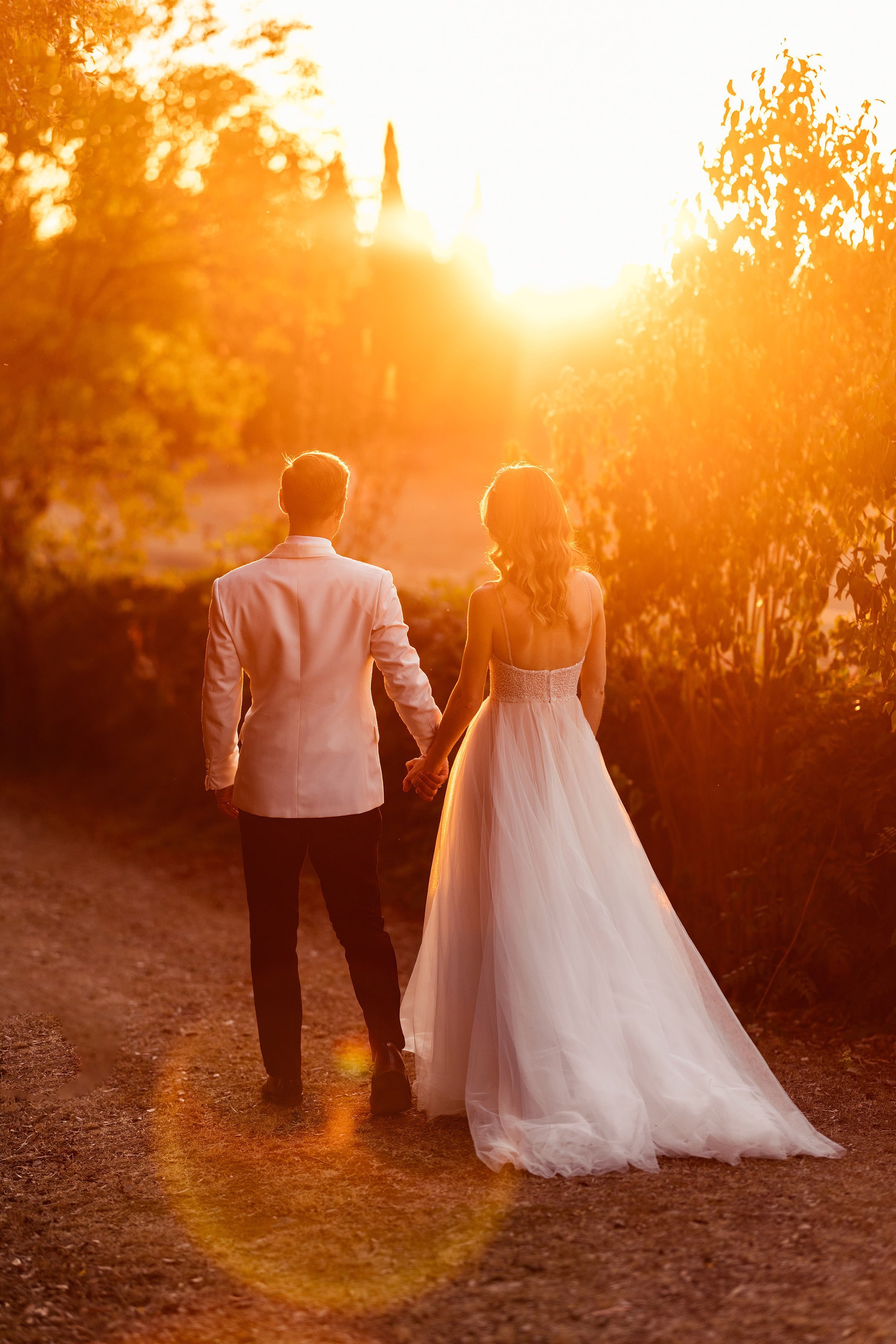 couple walk into tuscan sunset at la Pescaia resort