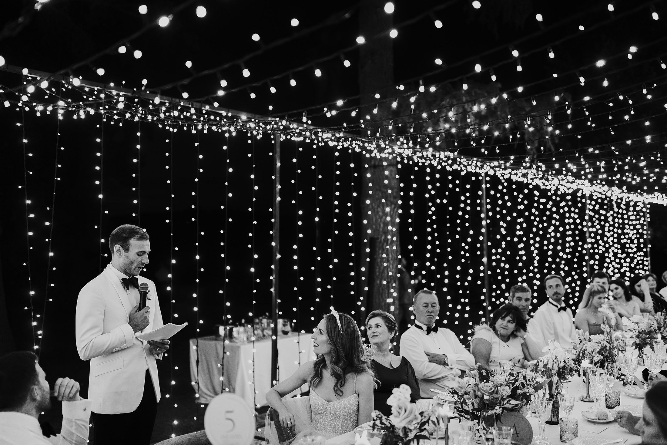 groom delivers speech in outdoor dinner reception at la Pescaia resort