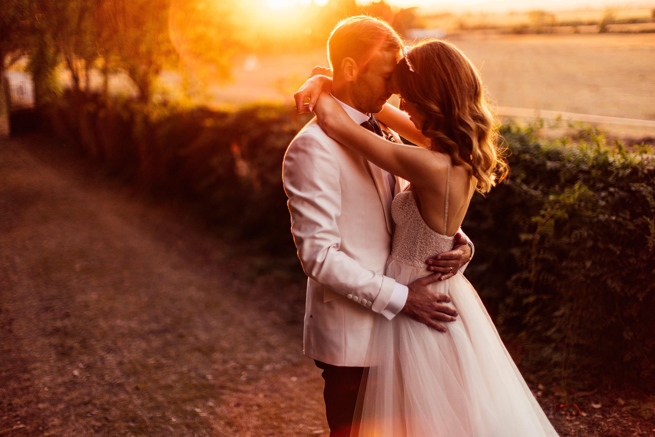 couple embrace at sunset in la Pescaia resort