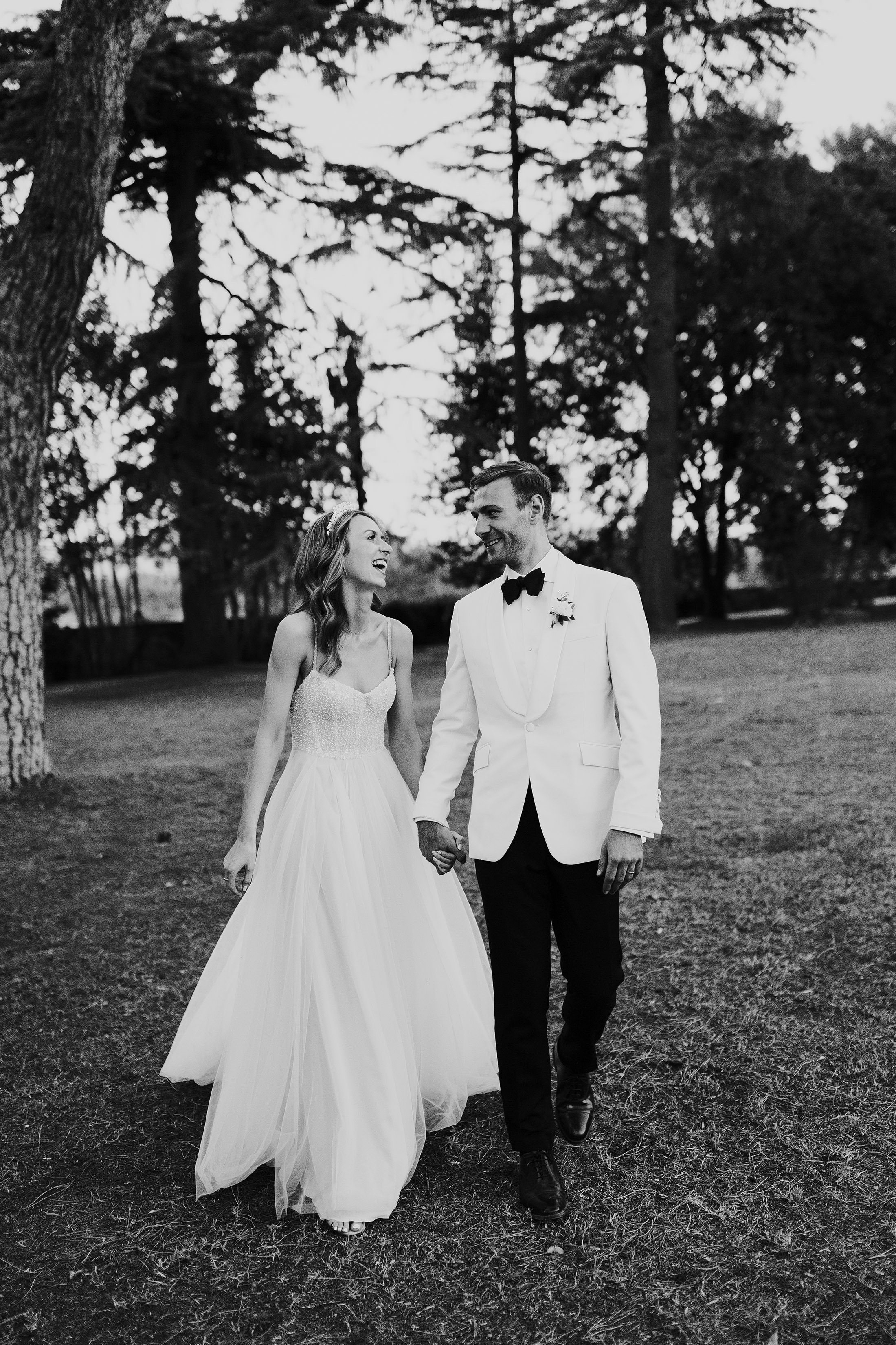 groom in white suit and bride in Helena kolon tule dress