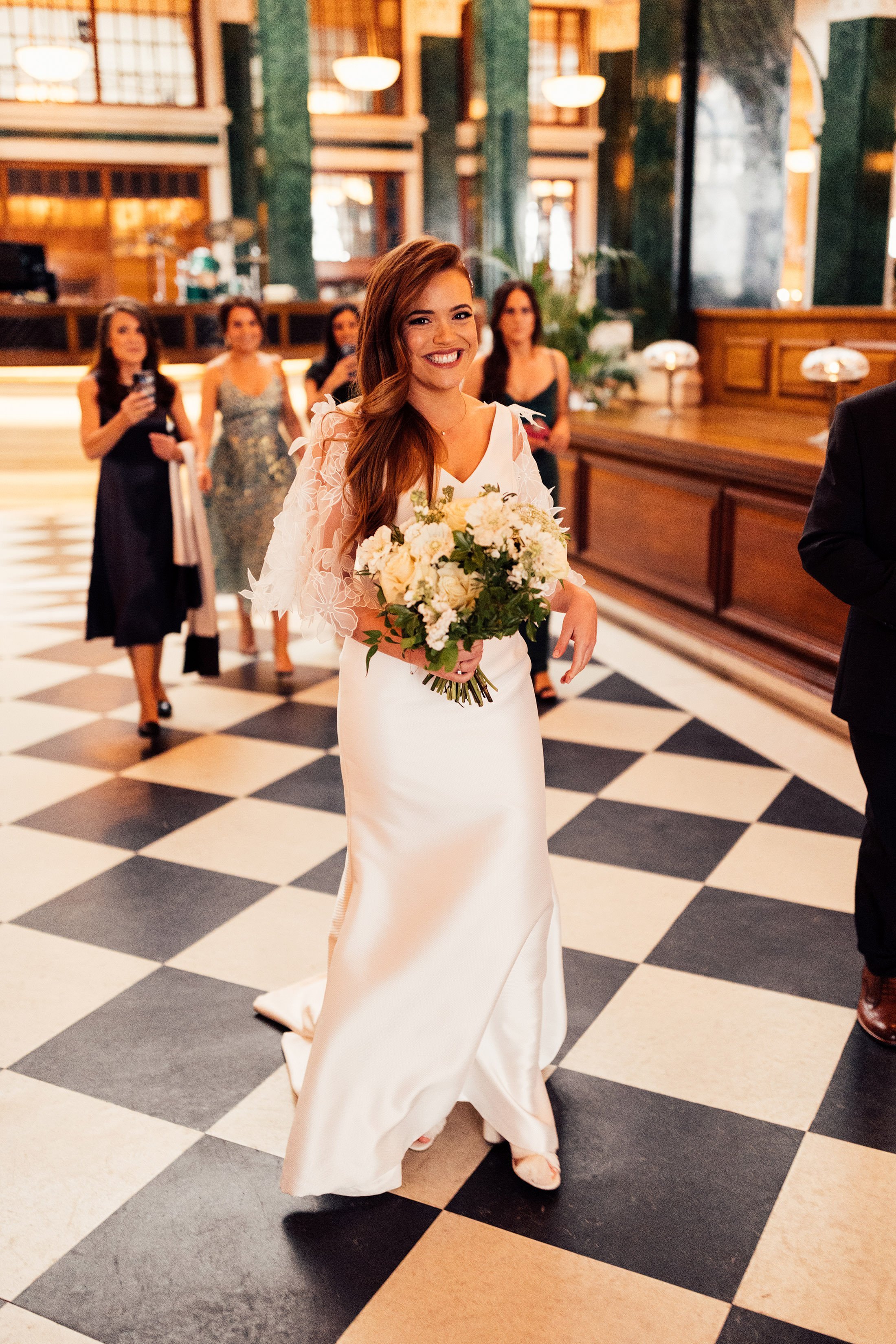 bride in suzanne neville dress walking through the ned London