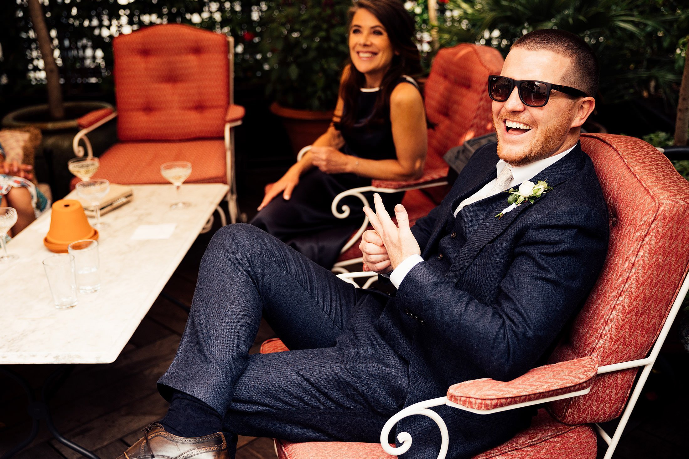 groom laughs in blue suit