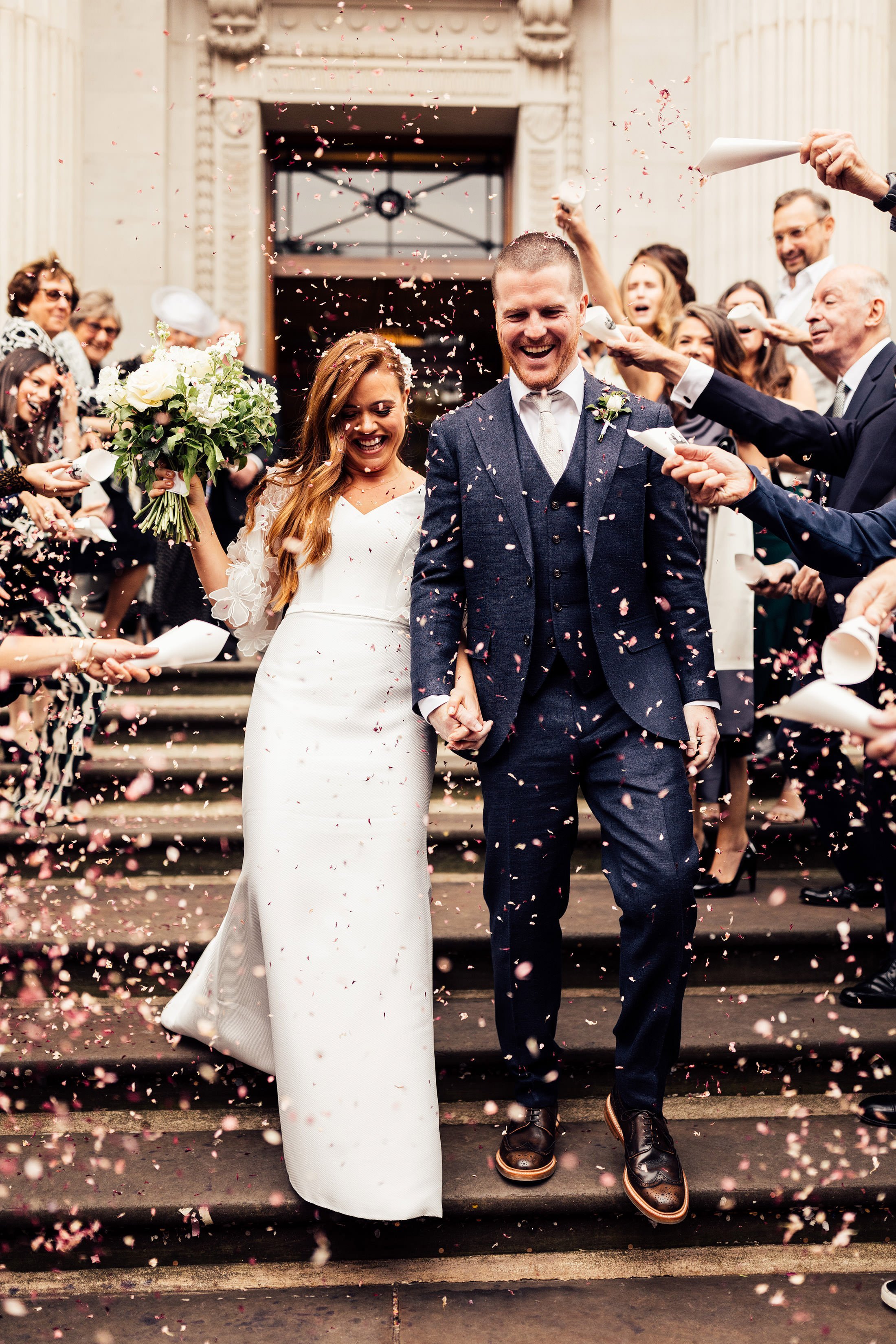 confetti moment outside town hall with bride in suzanne neville dress