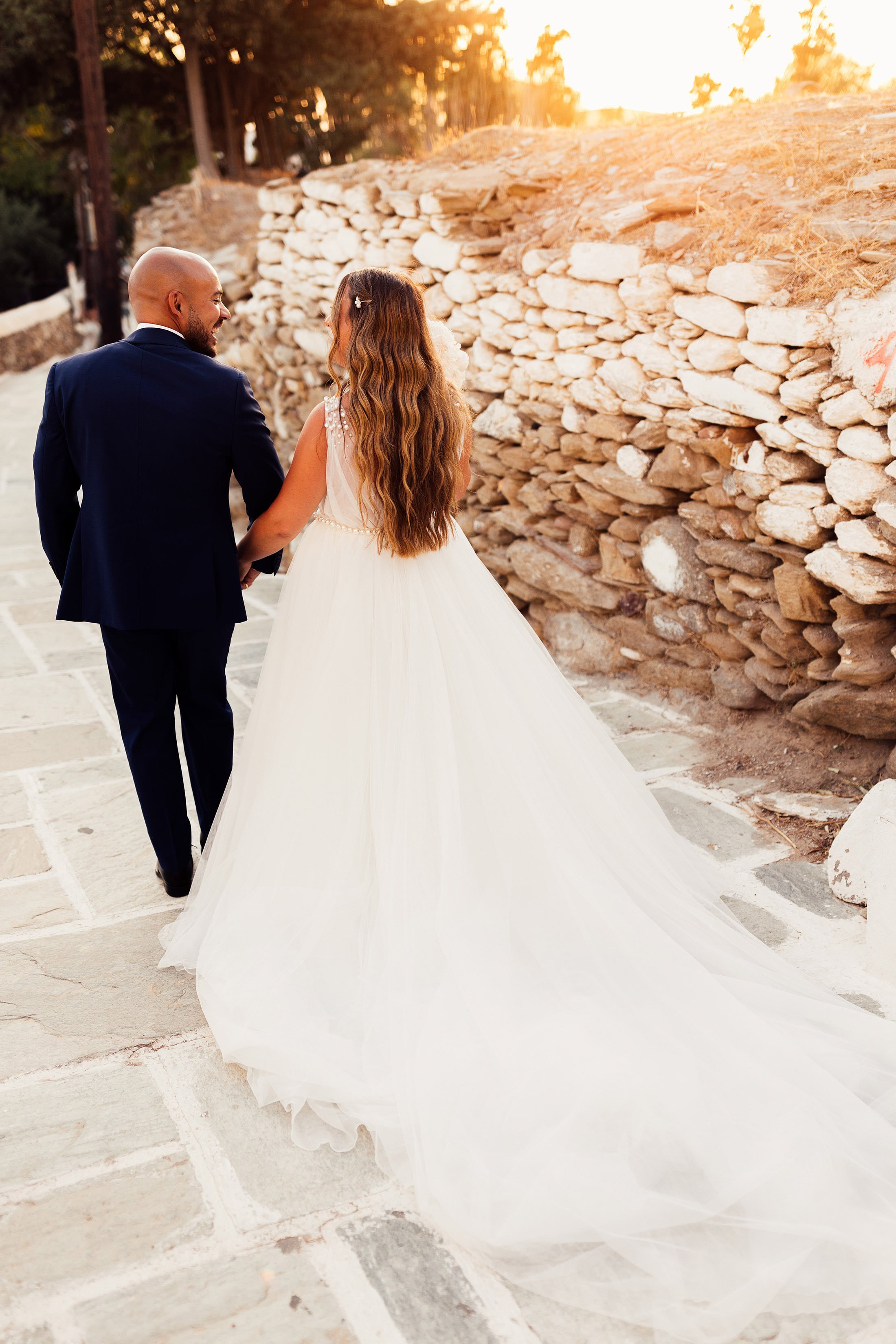 couple walk through traditional greek village
