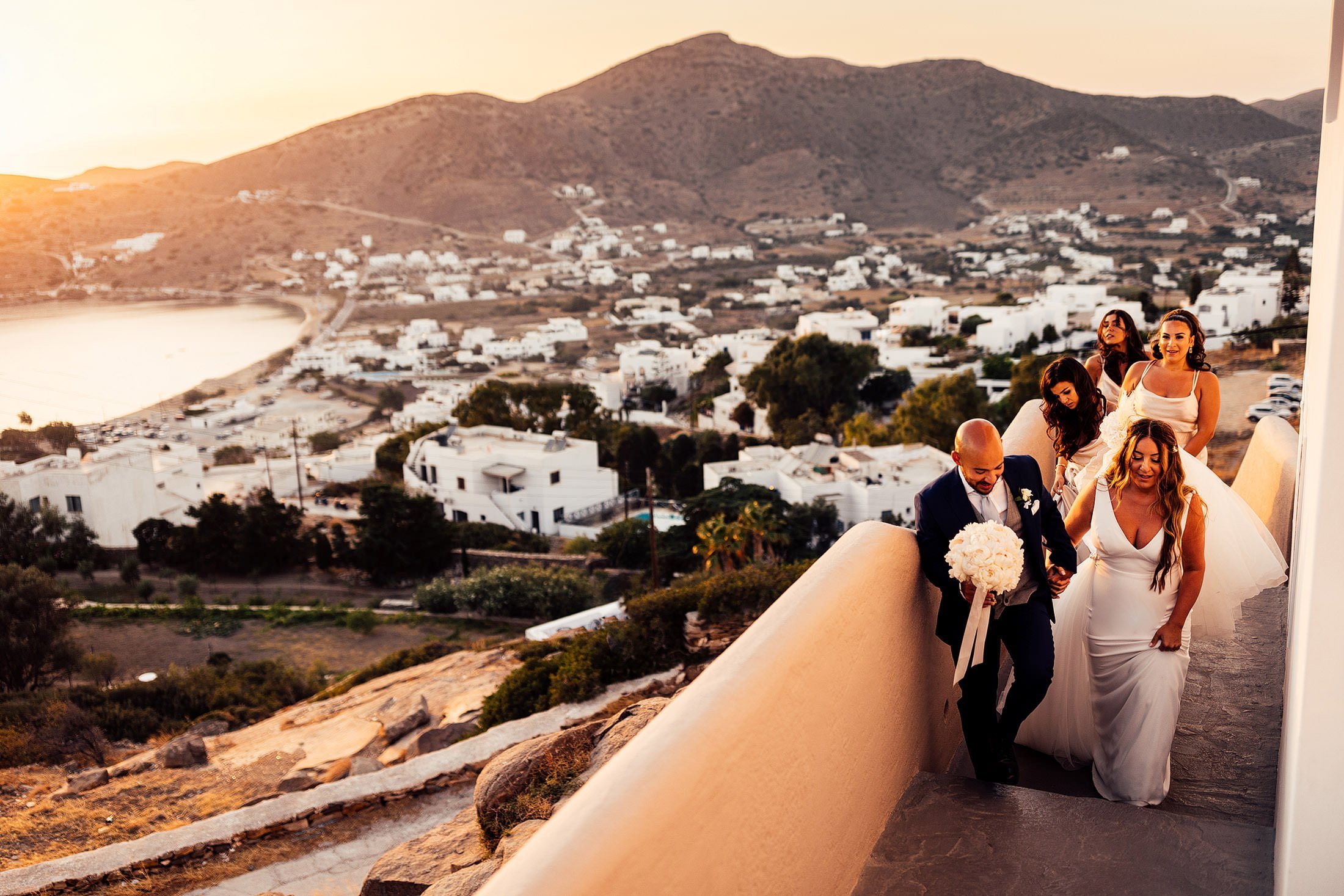 couple walk in sunset to iOS club Greece