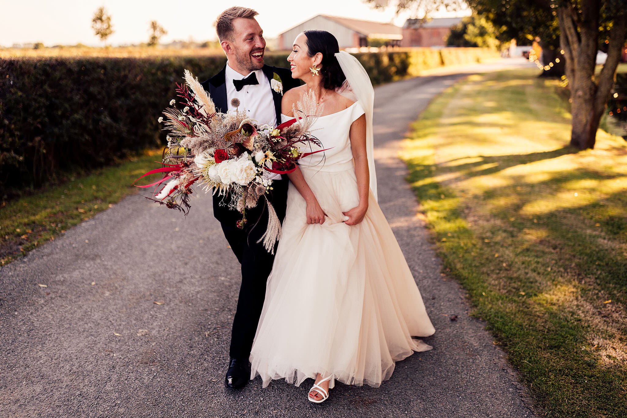 couple walk with groom in velvet tuxedo and bride in Jesus Peiro