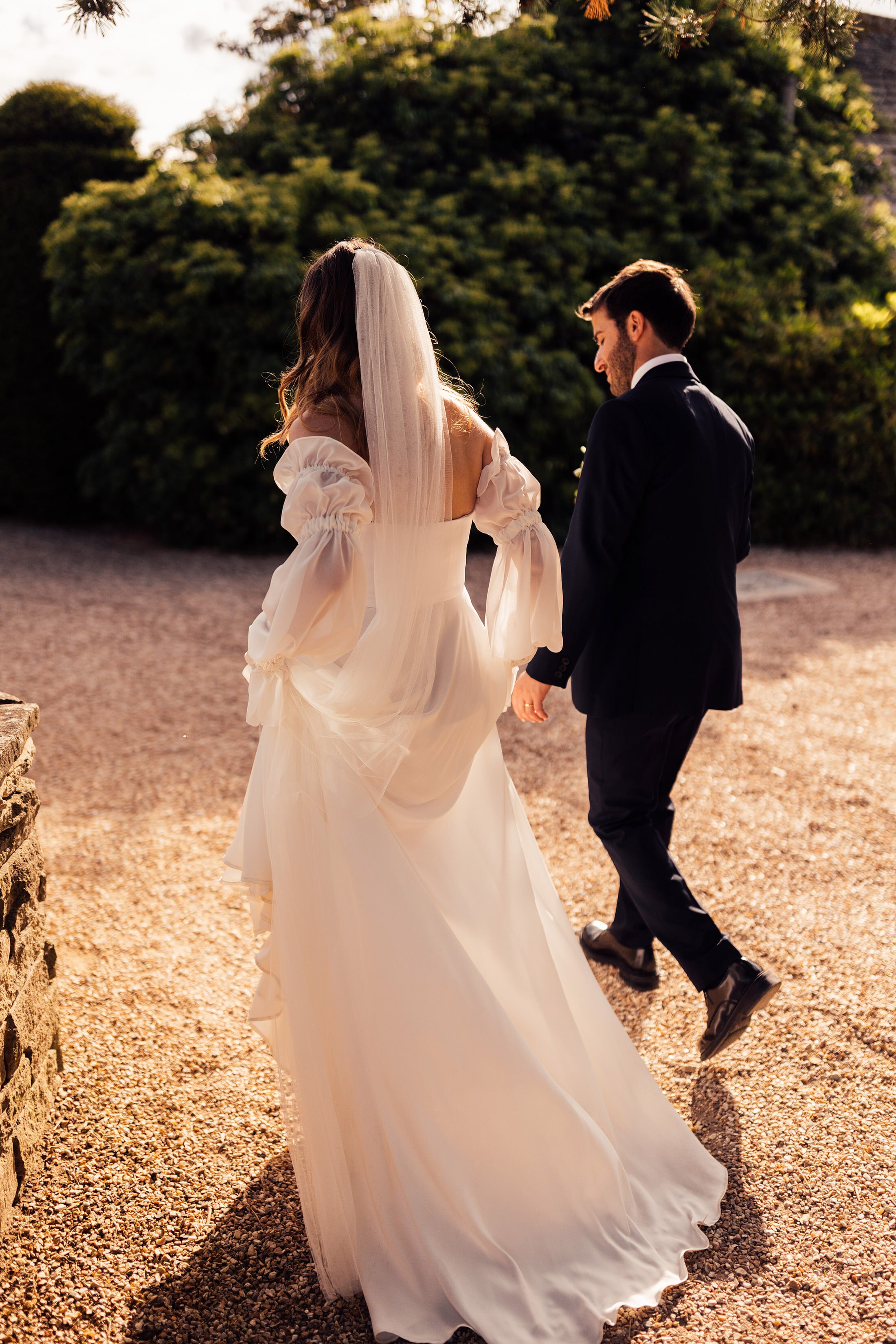 couple walk with bride in Jessica Bennett bespoke dress