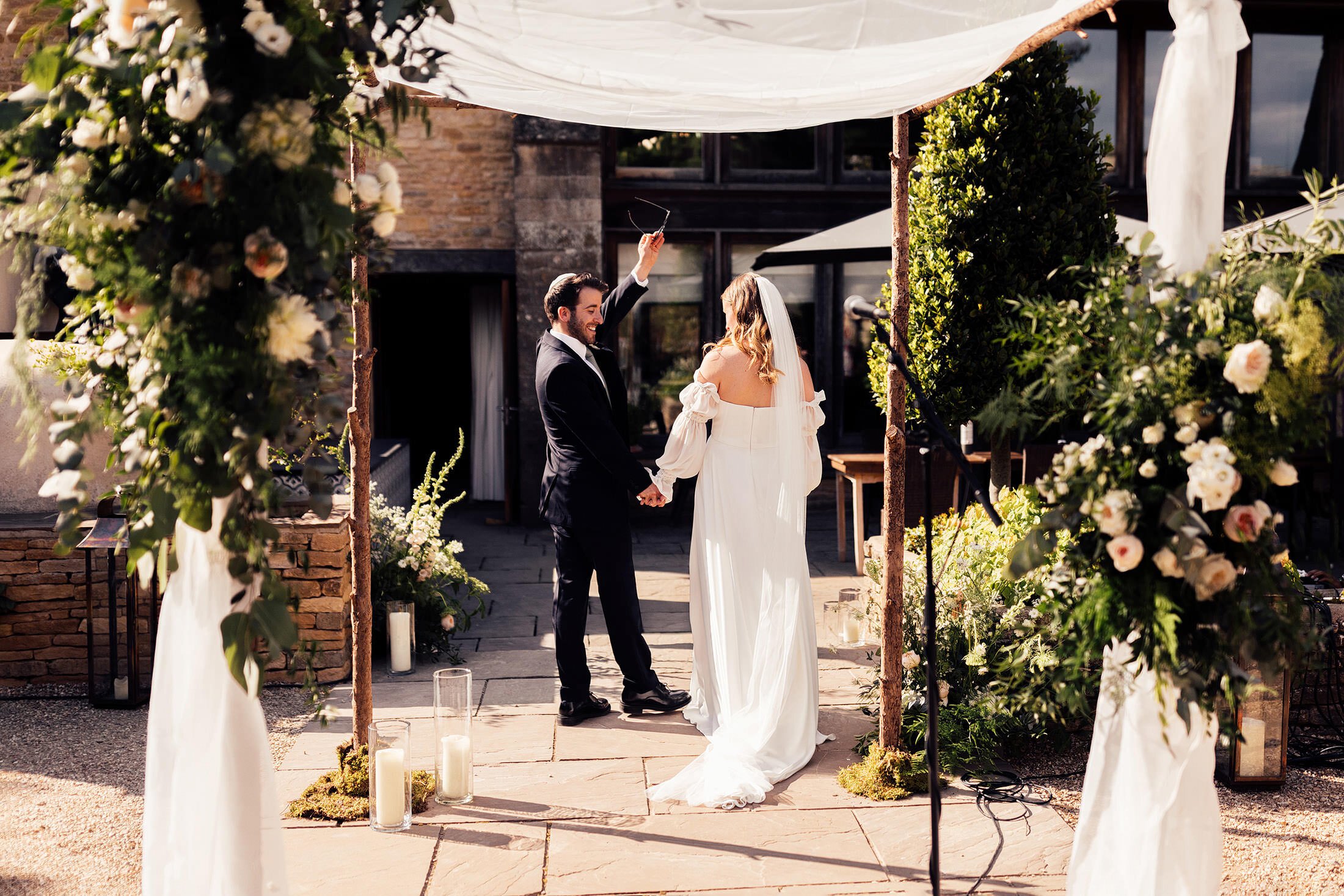 couple exit outdoor jewish ceremony at calcot manor