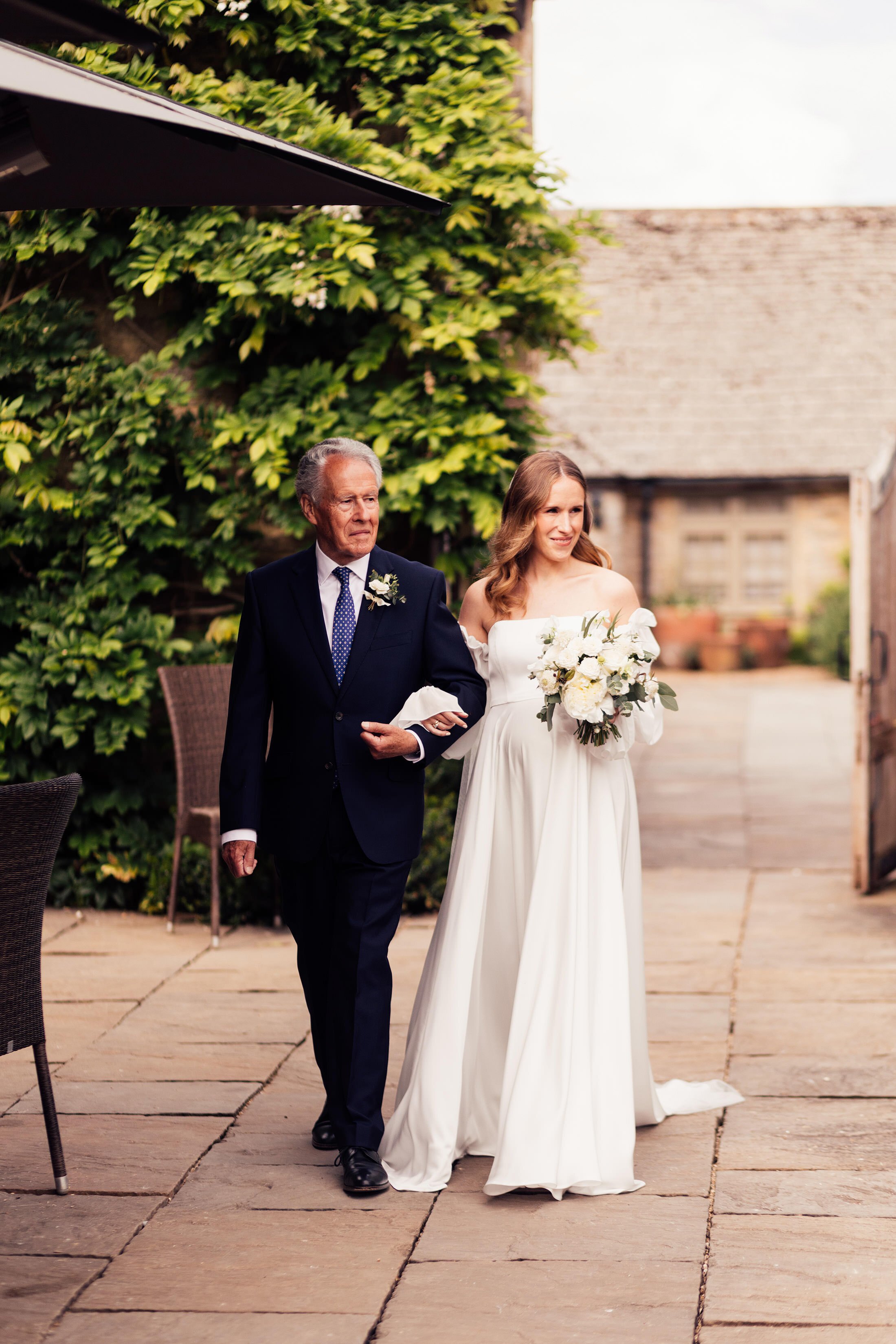 father walks bride down isle at outdoor ceremony