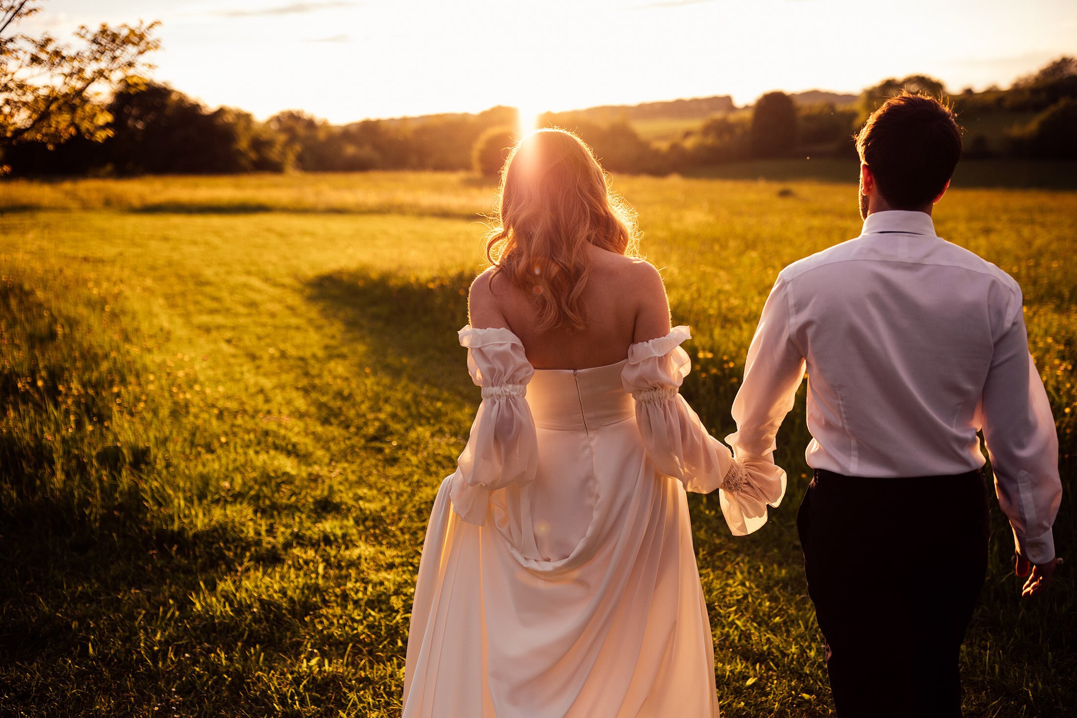 couple walk into sunset at calcot manor