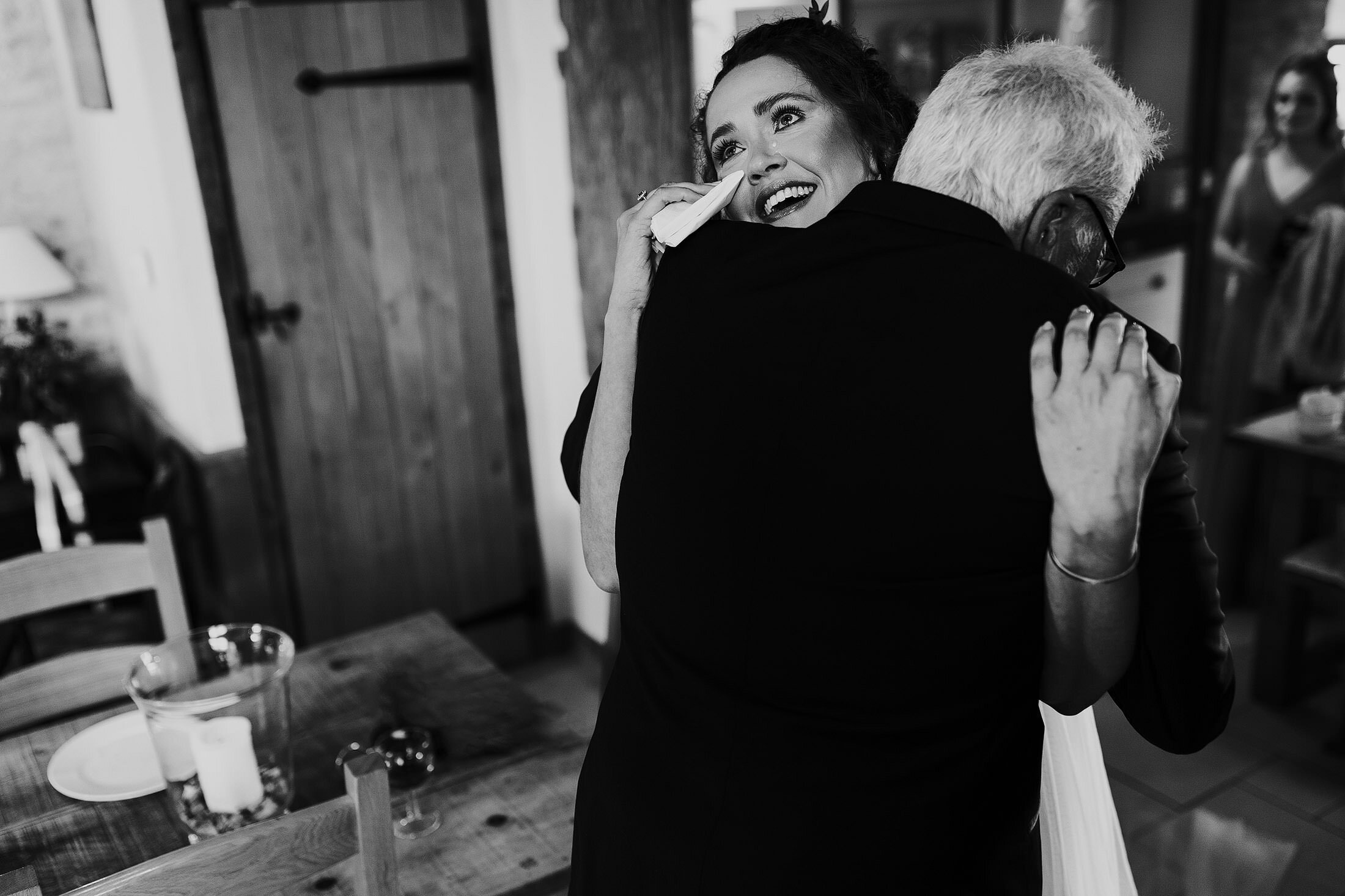 bride cries whilst hugging father