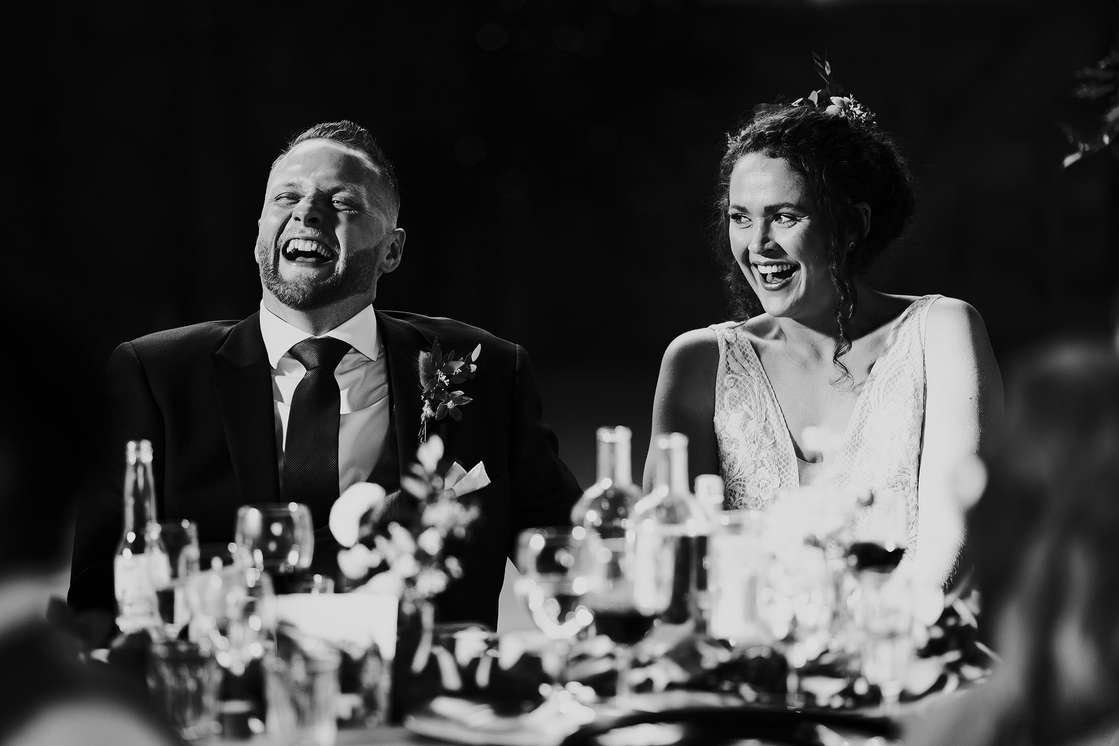 couple laugh at speeches in Cripps barn