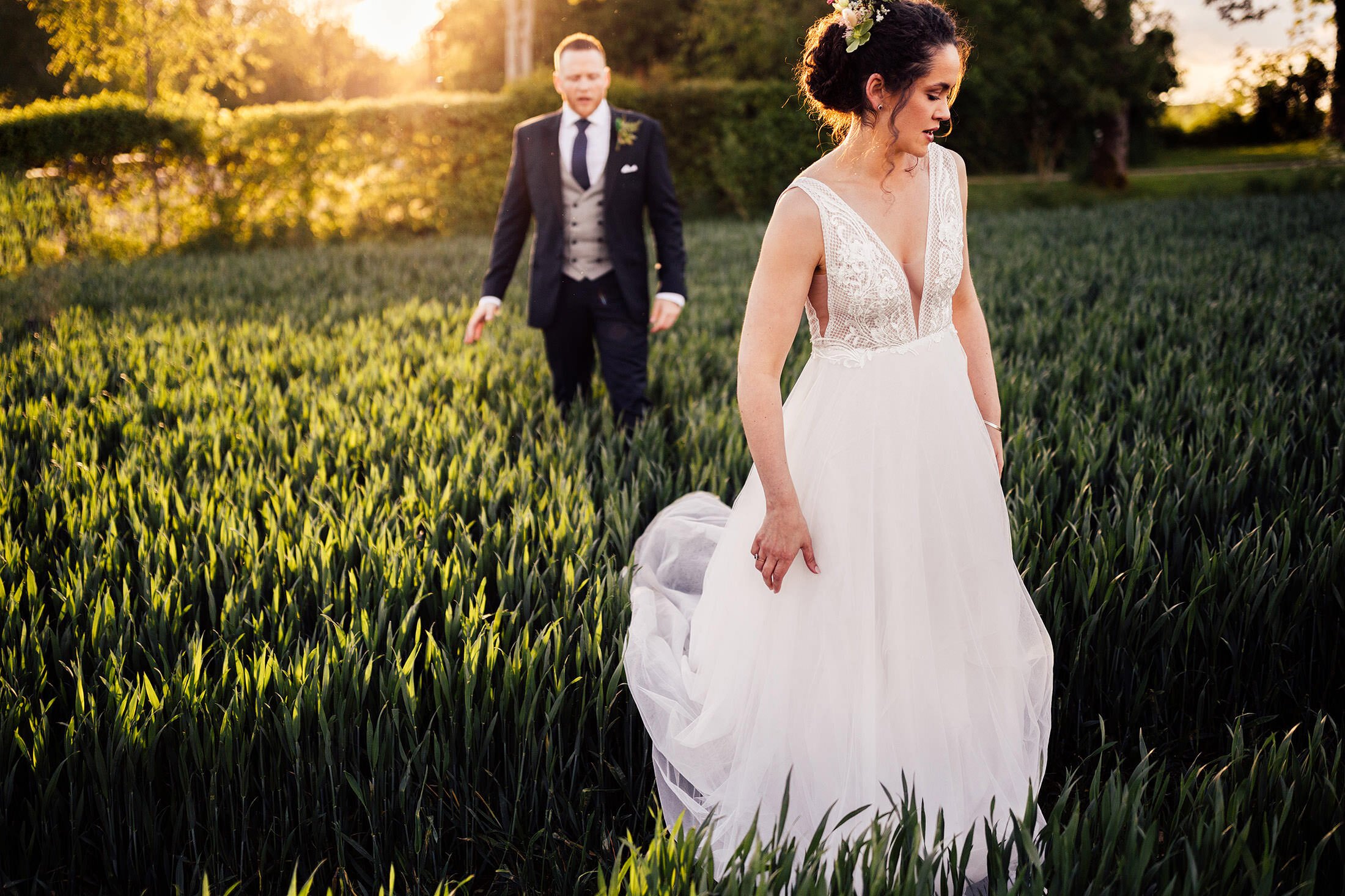 bride walks field in made with love bridal dress
