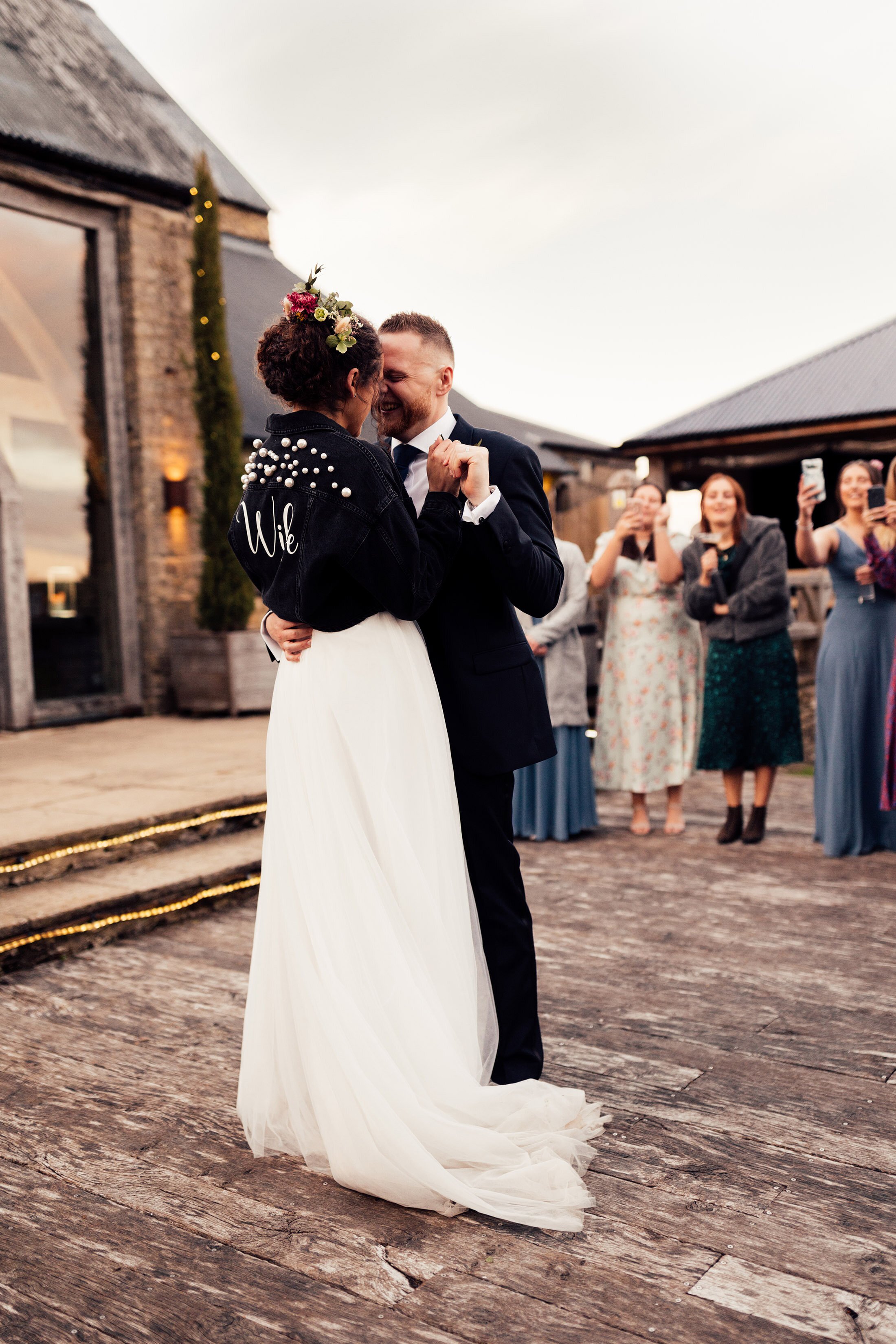 couple dance at sunset outside Cripps barn